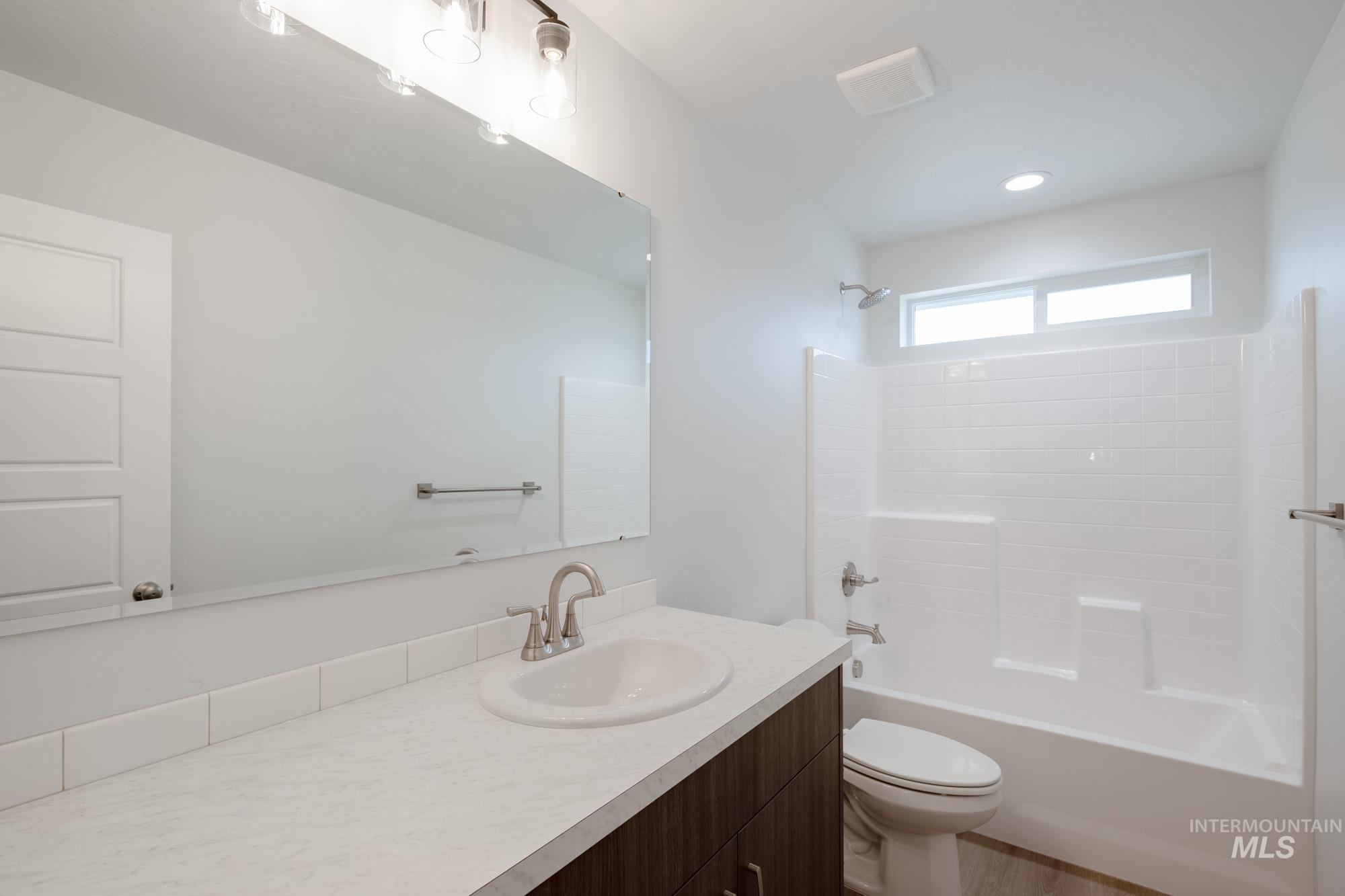 Full bathroom with bathtub / shower combination, vanity, and recessed lighting