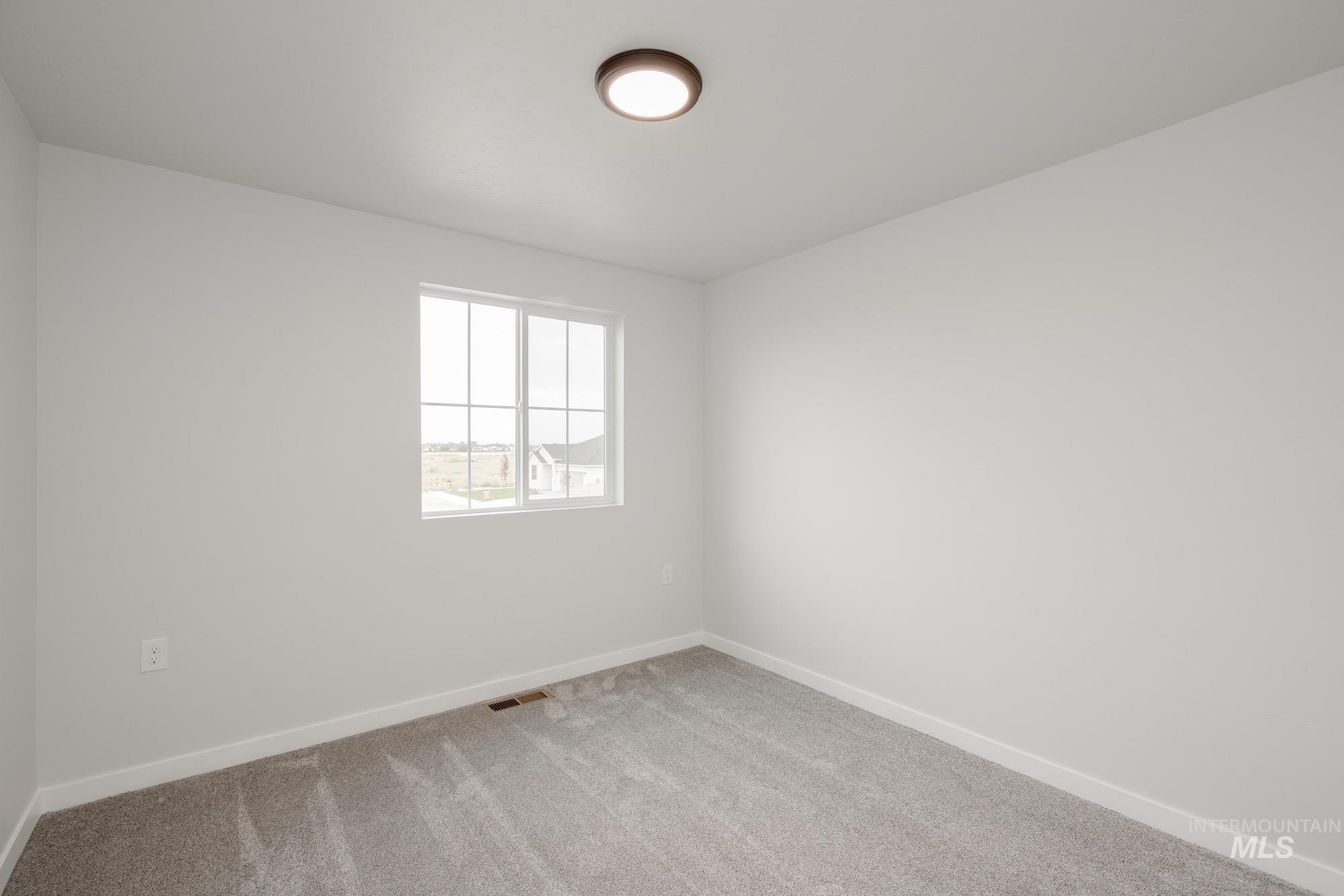 Unfurnished room featuring carpet and baseboards