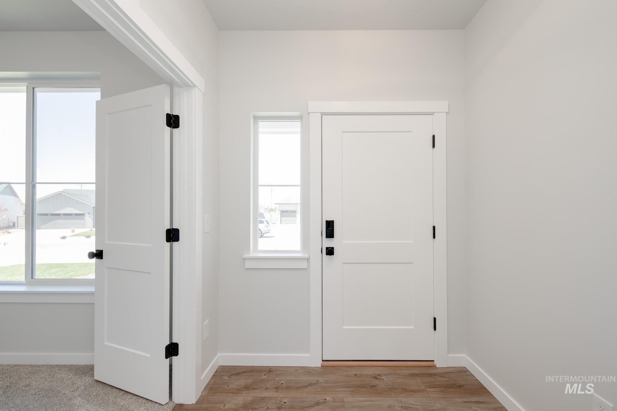 Foyer entrance with baseboards and light wood-type flooring