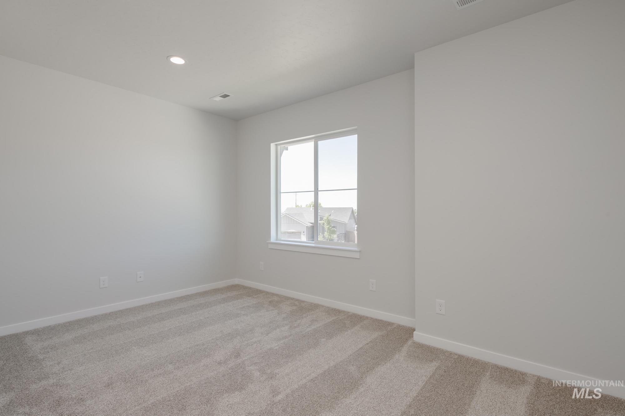Spare room featuring light carpet and recessed lighting