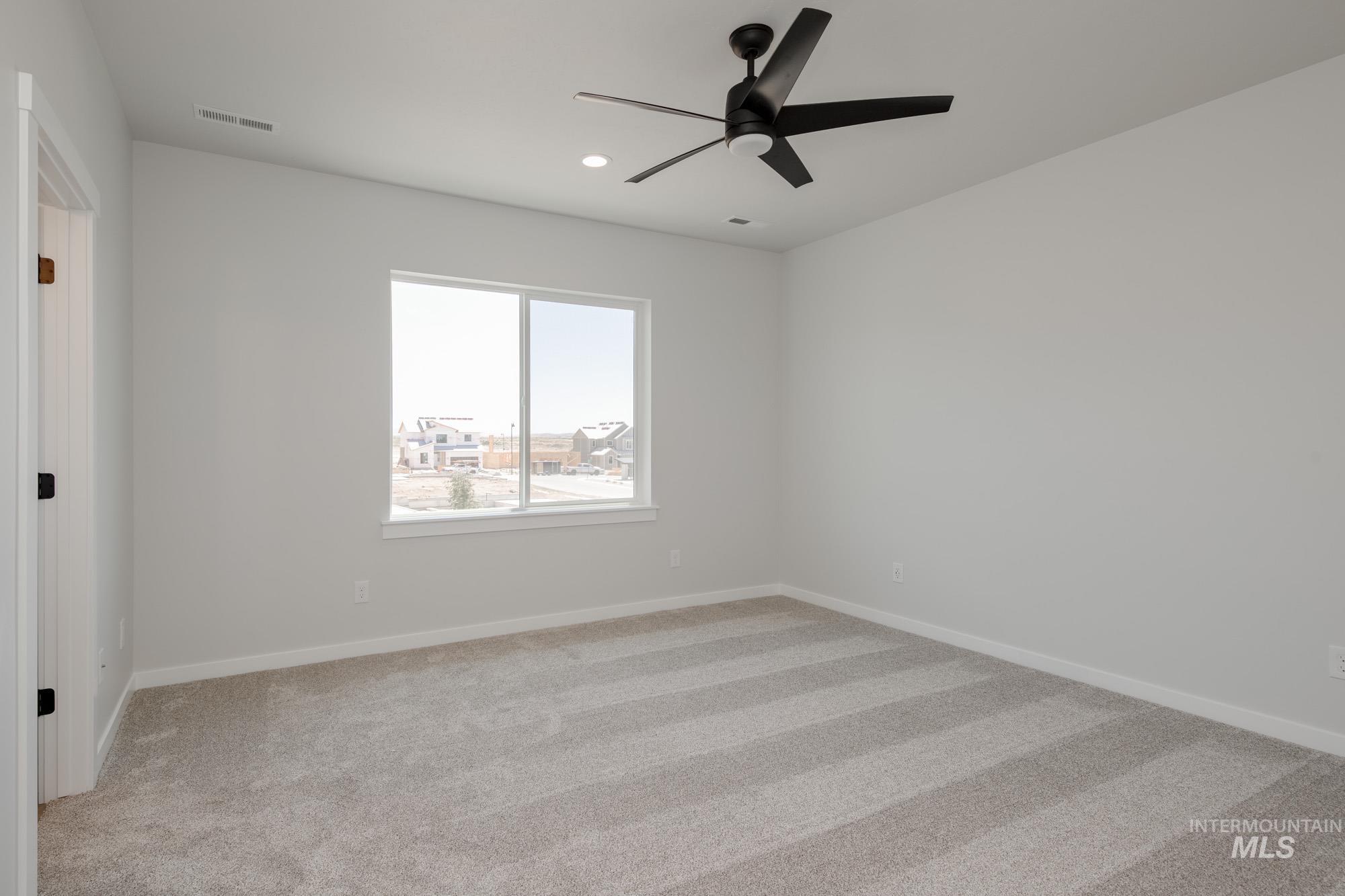 Spare room featuring light carpet, recessed lighting, and ceiling fan