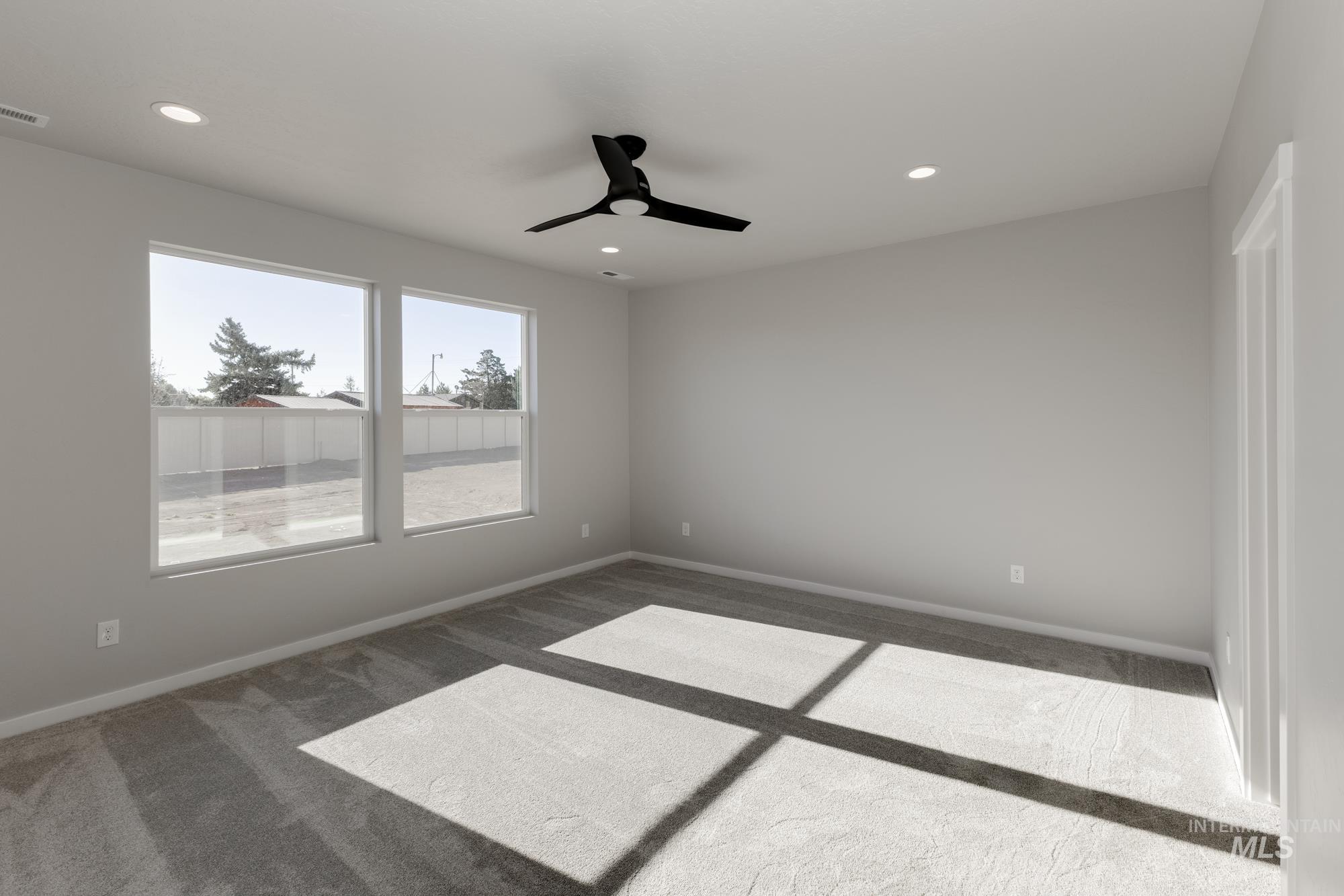 Carpeted empty room featuring recessed lighting and a ceiling fan