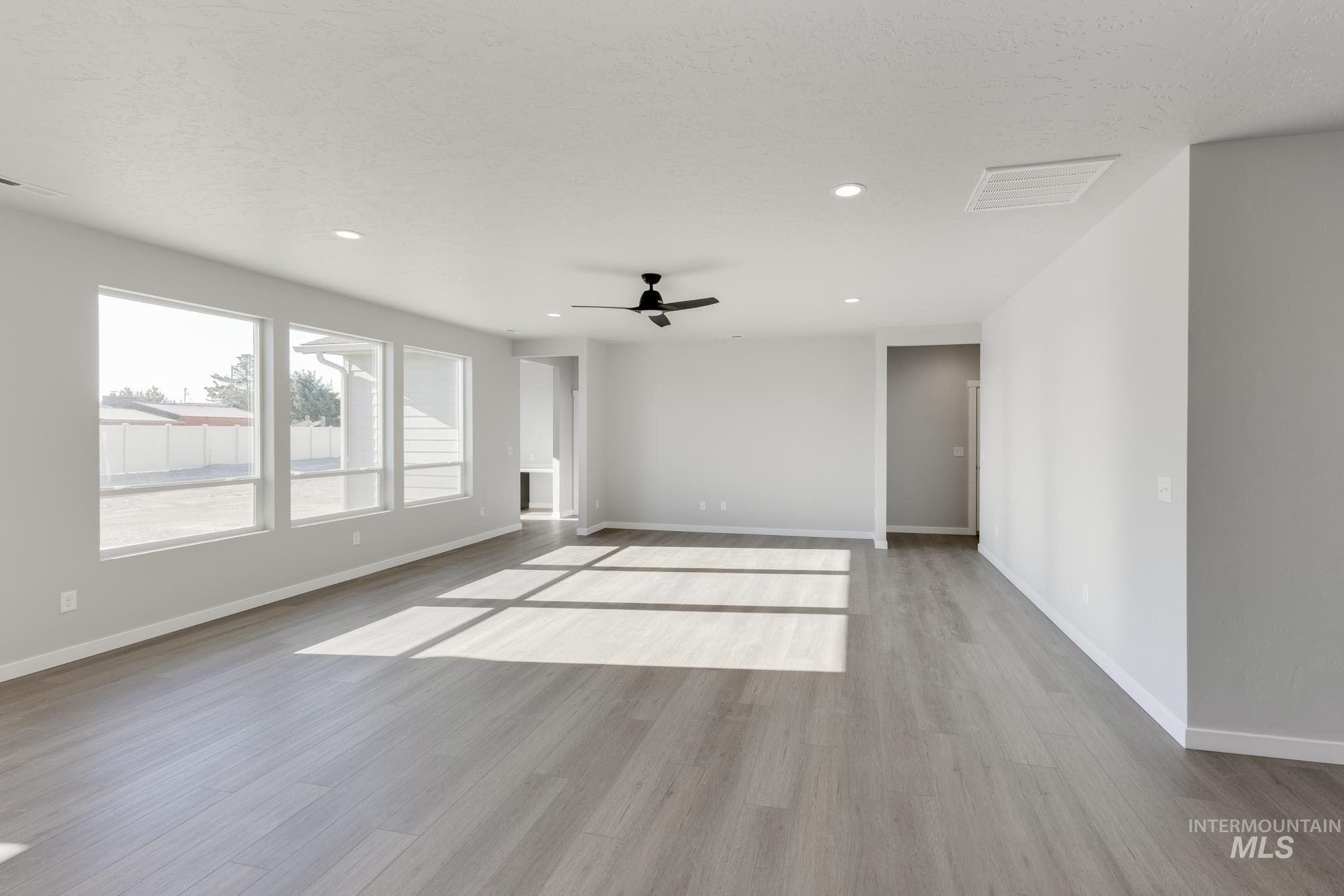 Spare room with light wood-style floors, recessed lighting, and ceiling fan