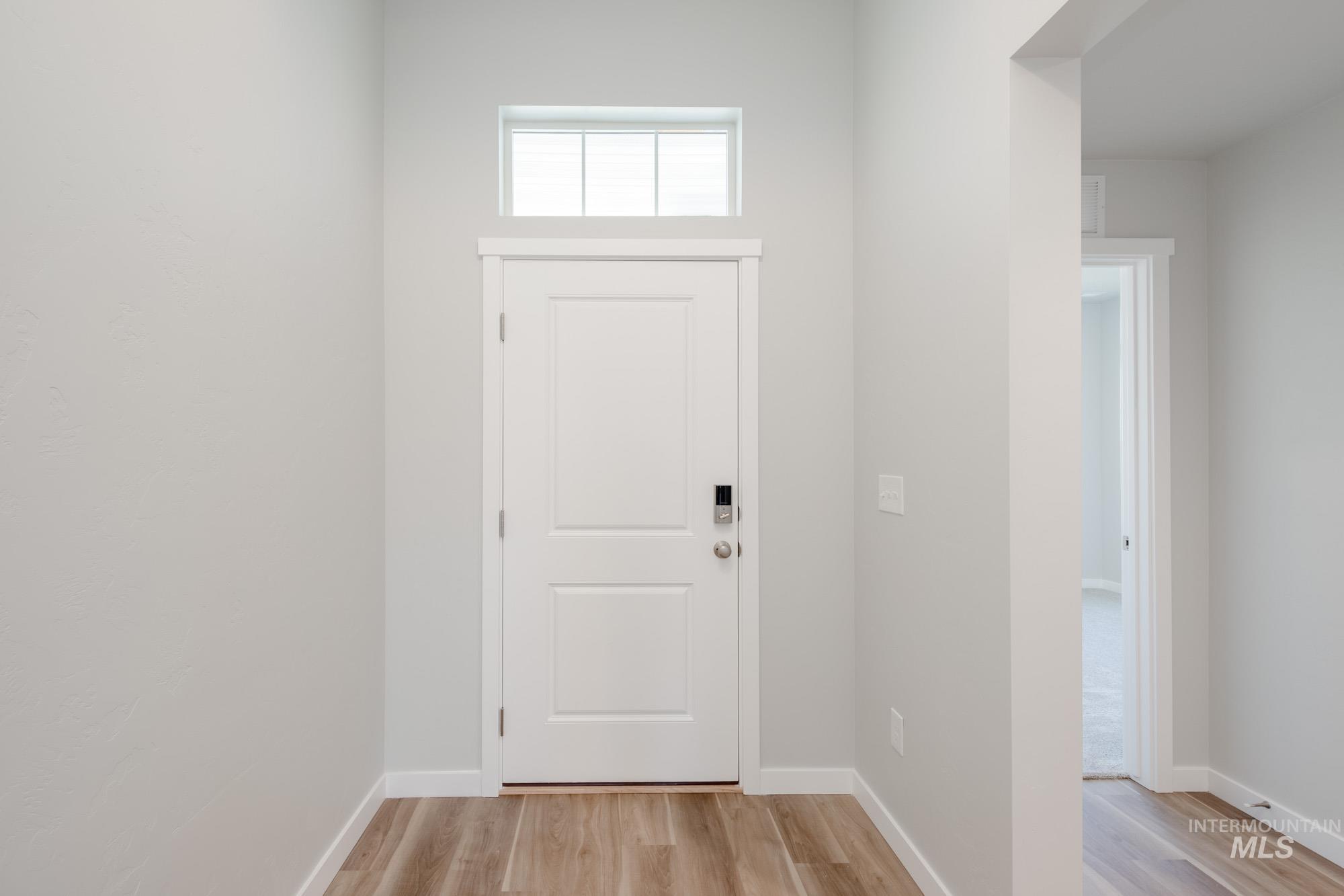 Foyer featuring baseboards and light wood-type flooring