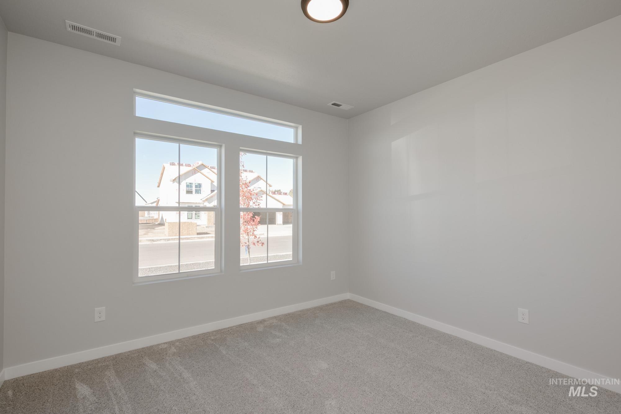 Carpeted empty room with baseboards