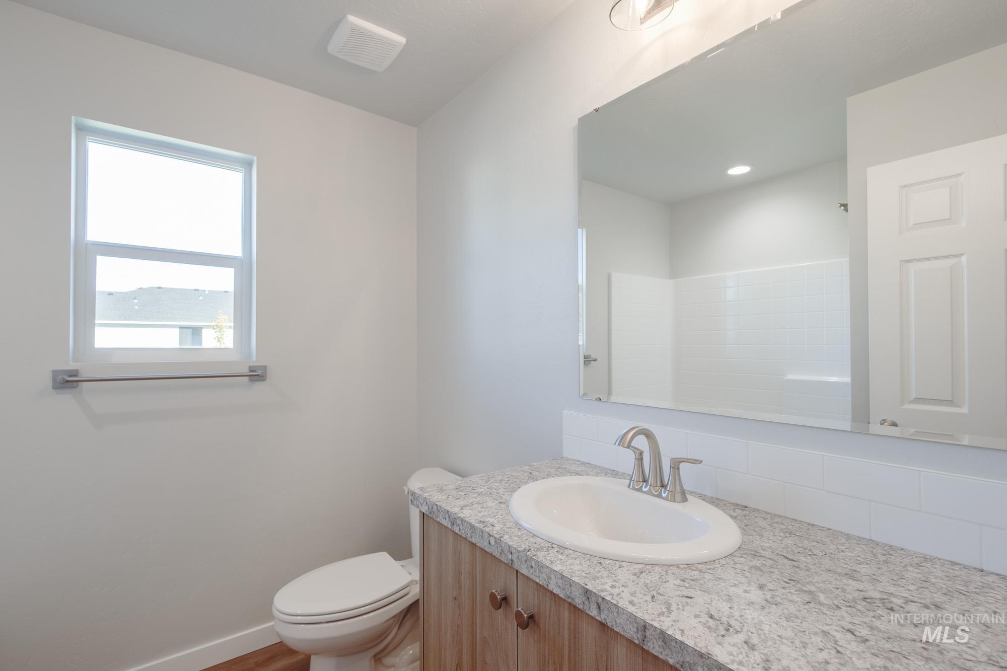 Bathroom with vanity and a shower