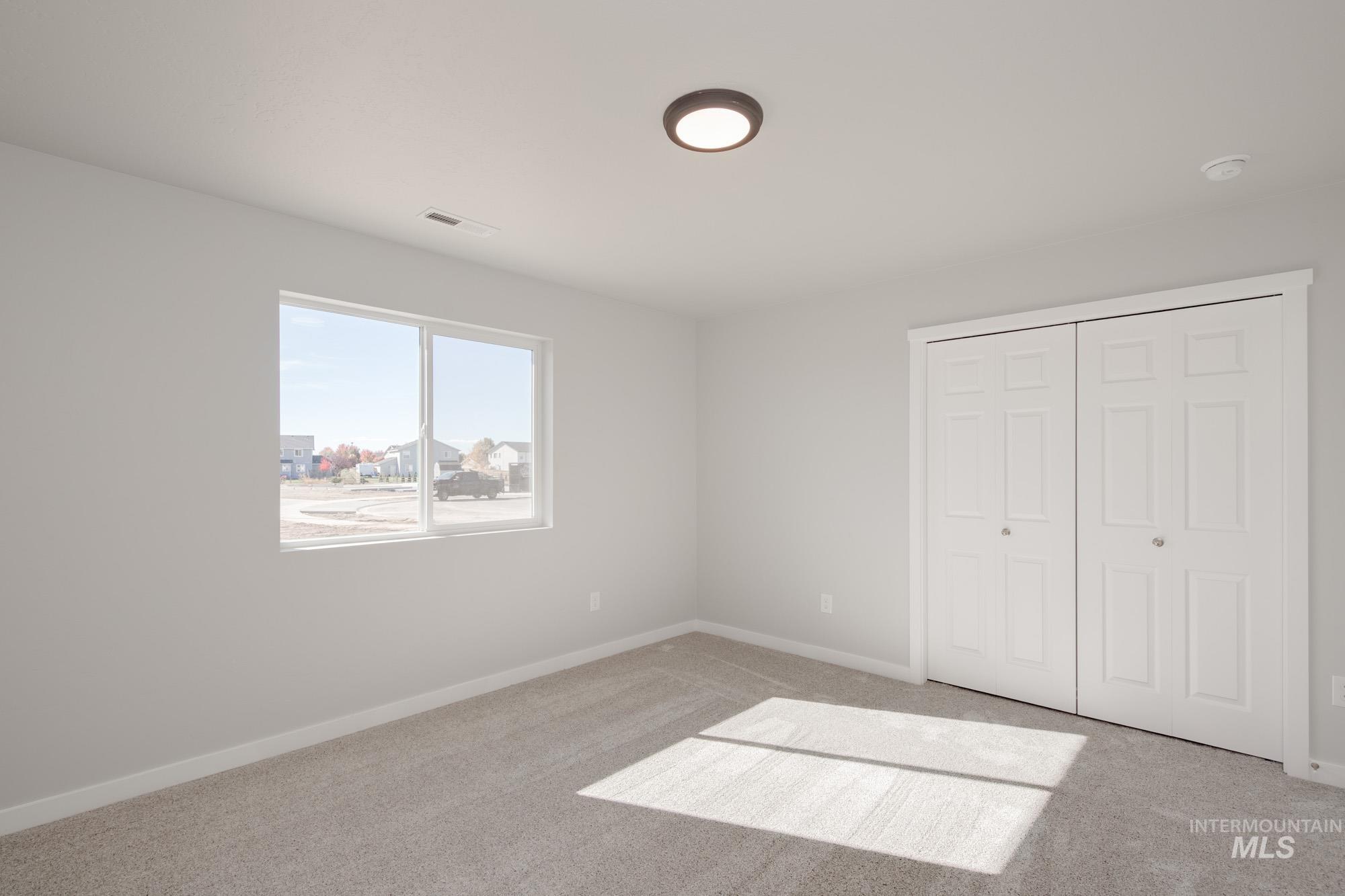 Unfurnished bedroom featuring carpet flooring and a closet