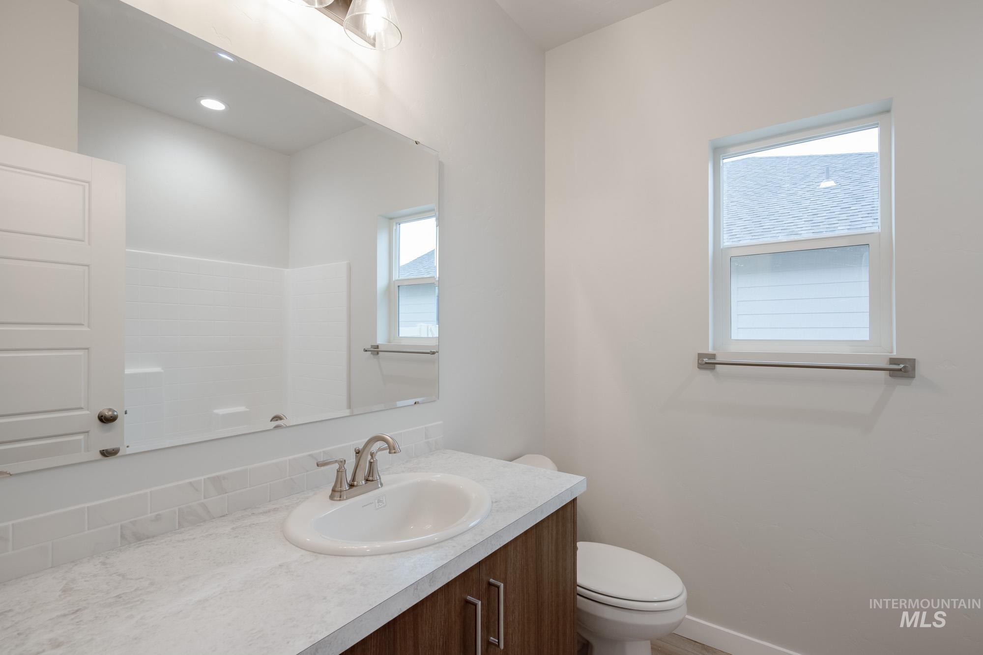 Bathroom featuring vanity and toilet