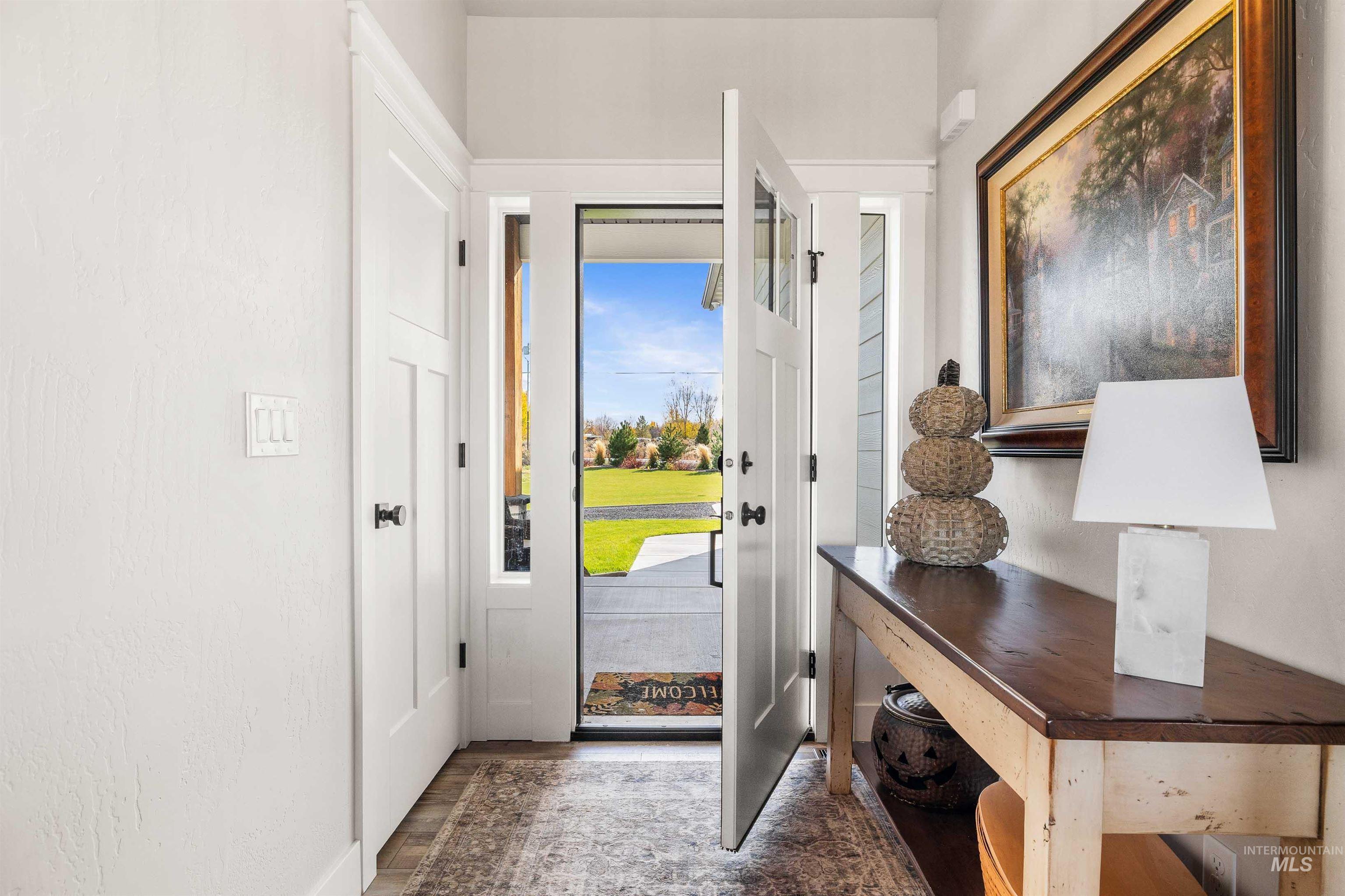 Foyer entrance featuring dark wood-style flooring