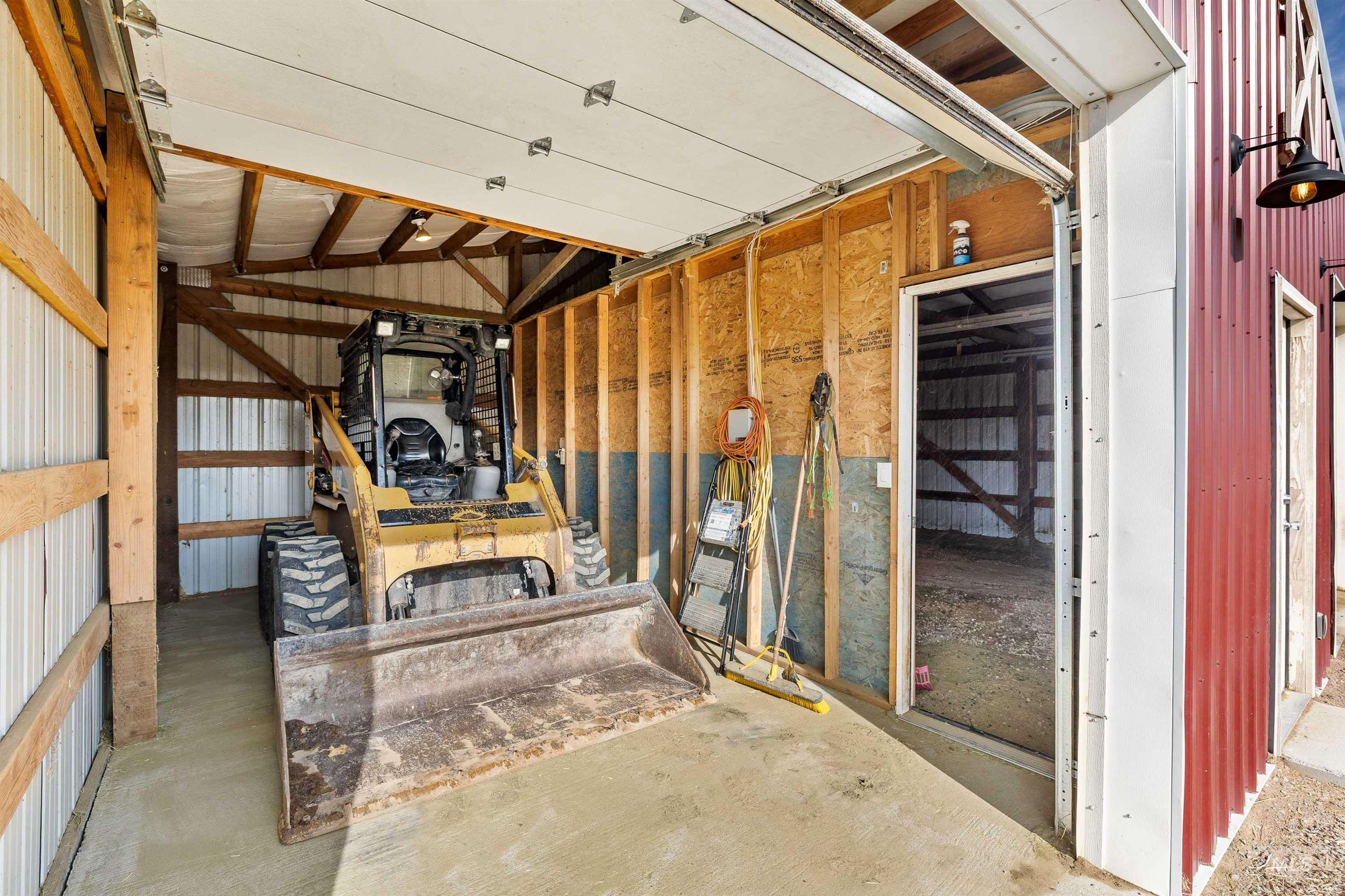 View of shop interior, including concrete floors and loft.