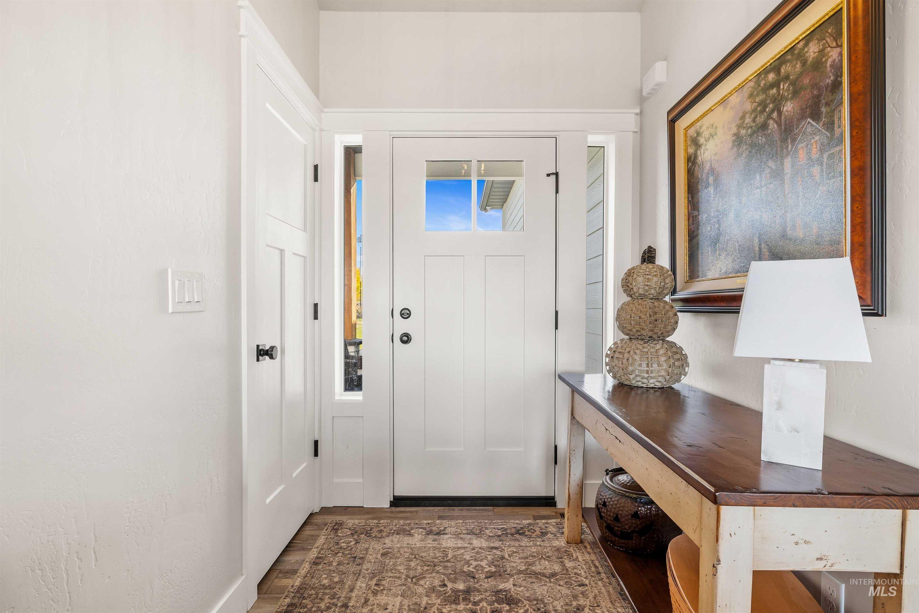 Entrance foyer with dark wood-style flooring