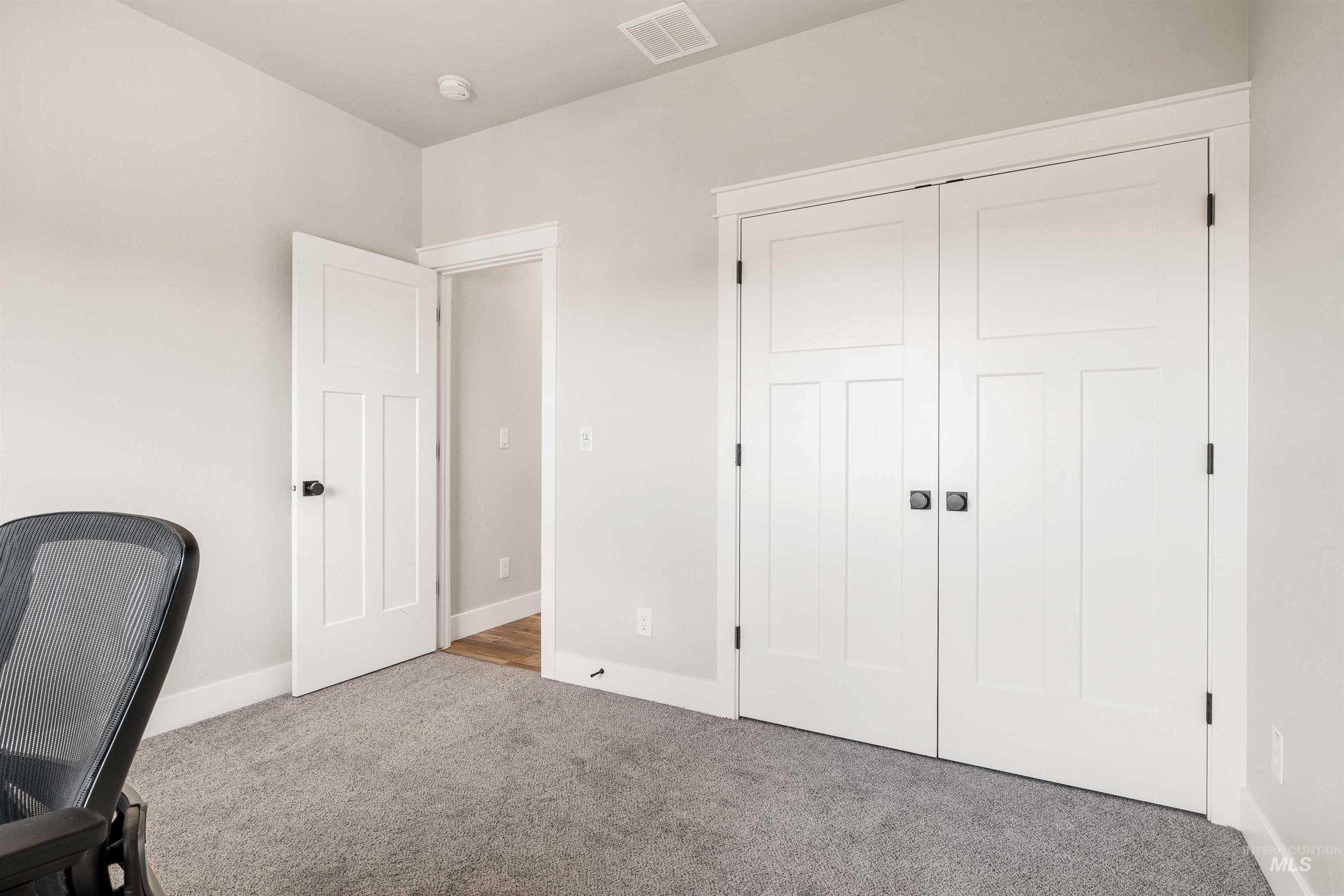 Unfurnished office featuring carpet floors and baseboards