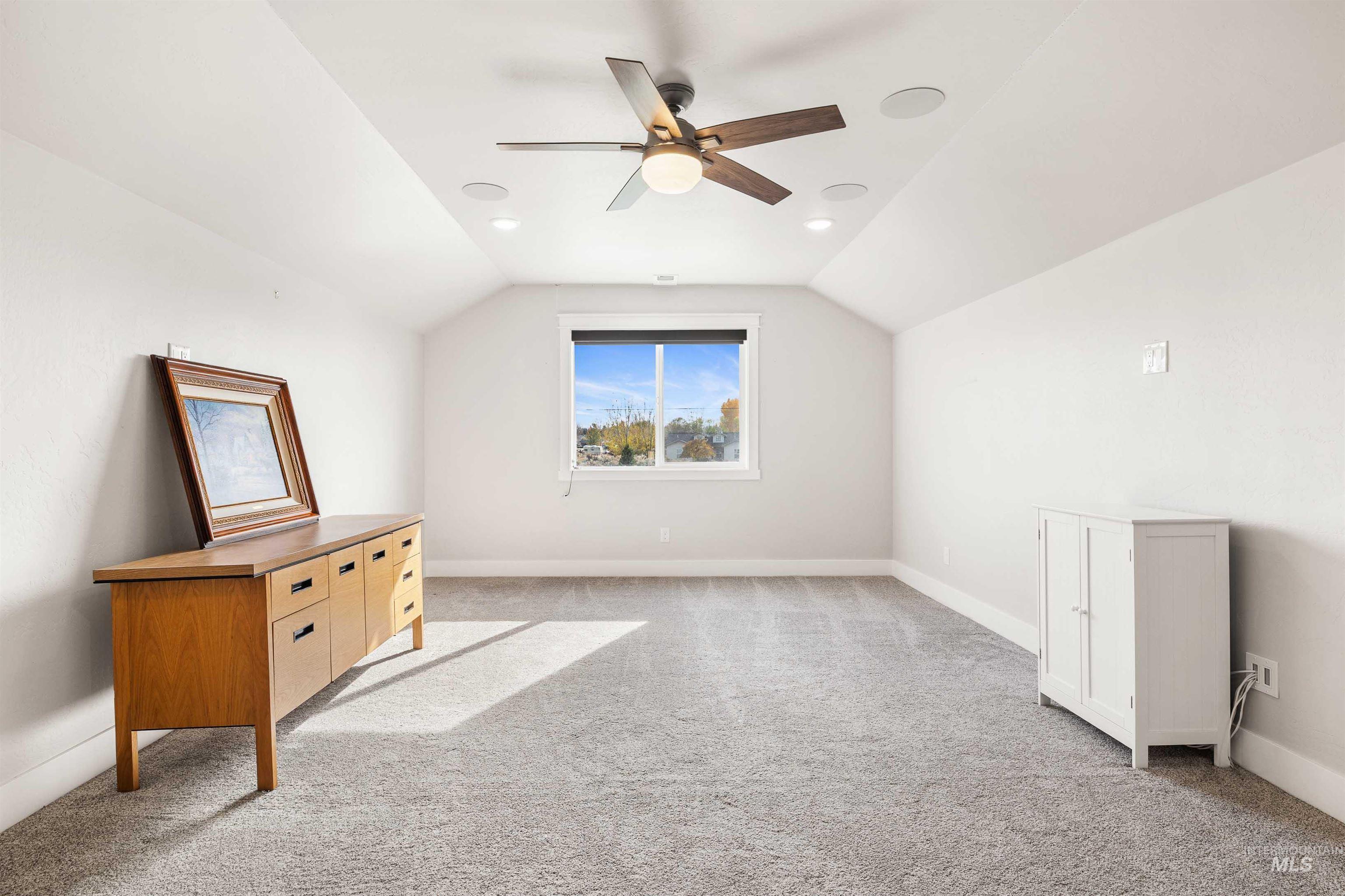 Bonus room featuring light colored carpet, vaulted ceiling, ceiling fan, and recessed lighting