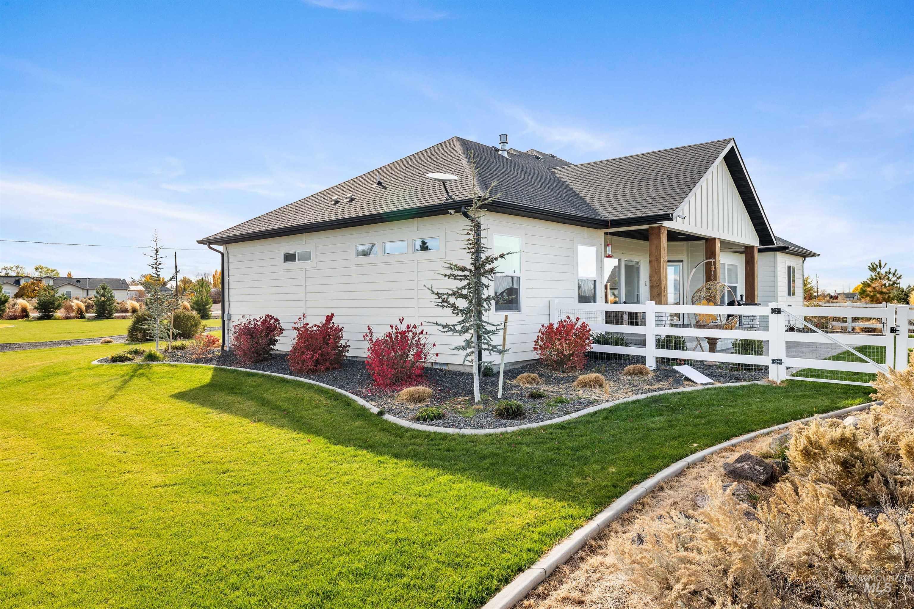 View of side of property with roof with shingles and board and batten siding