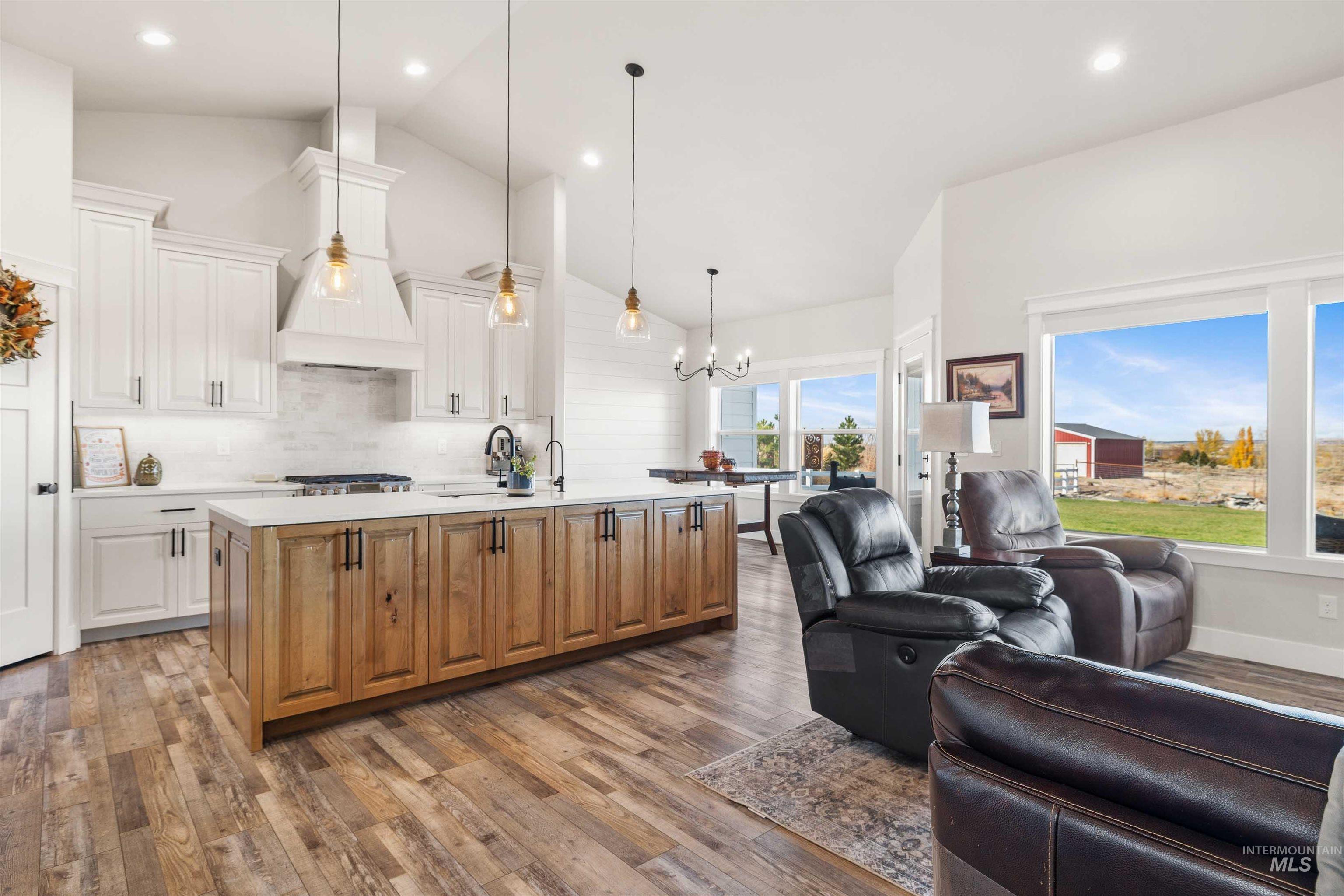 Kitchen featuring brown cabinetry, open floor plan, white cabinetry, dark wood-type flooring, and recessed lighting