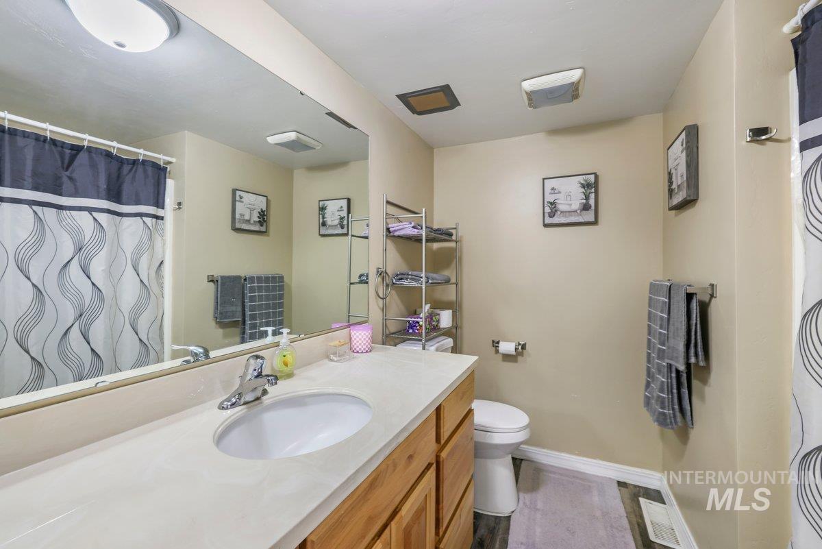 Full bathroom with a shower with curtain and vanity