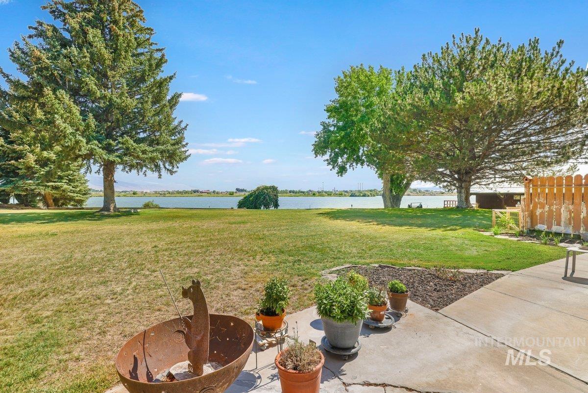 View of yard featuring a water view and a patio
