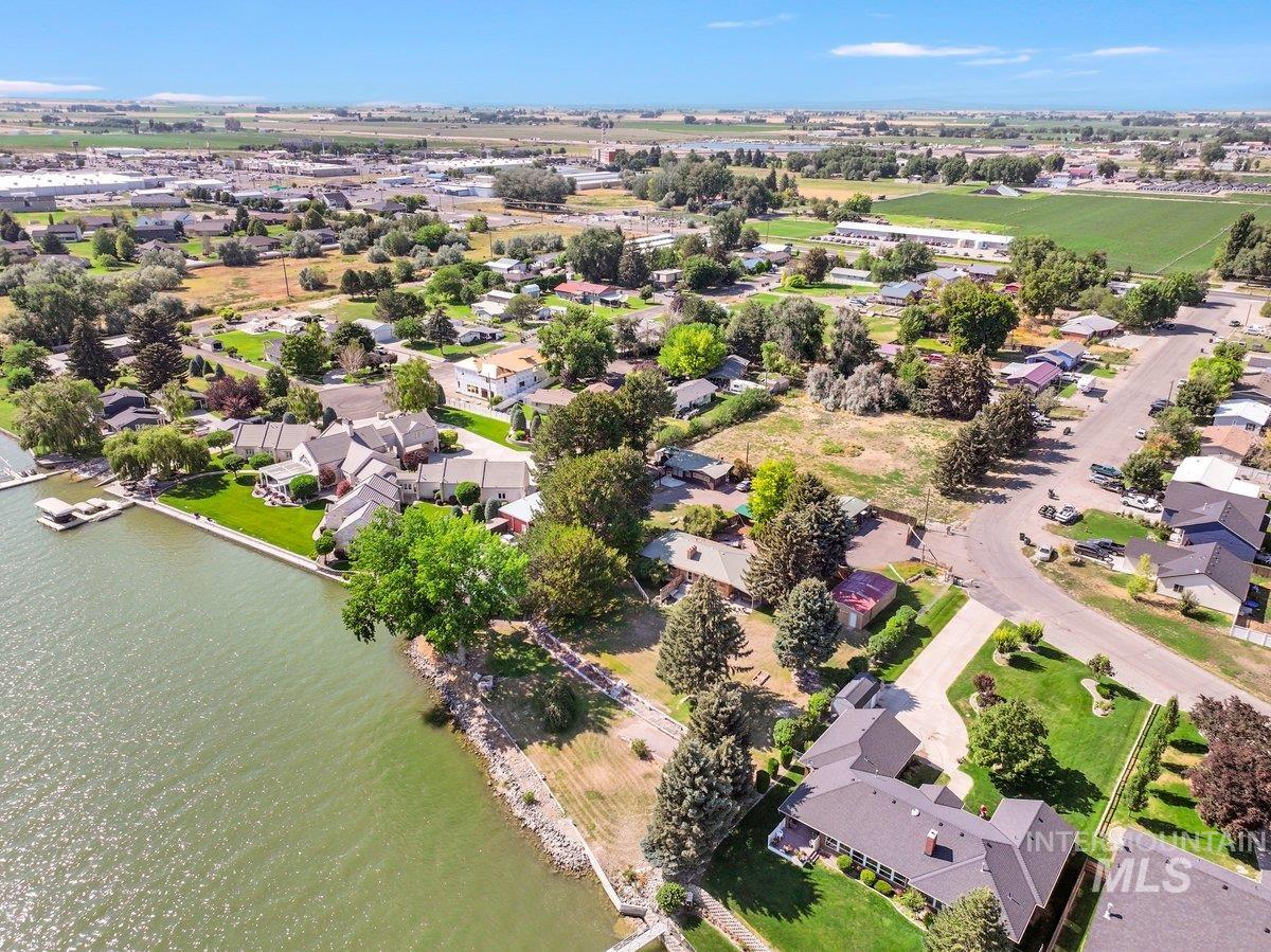 Aerial perspective of suburban area featuring a nearby body of water