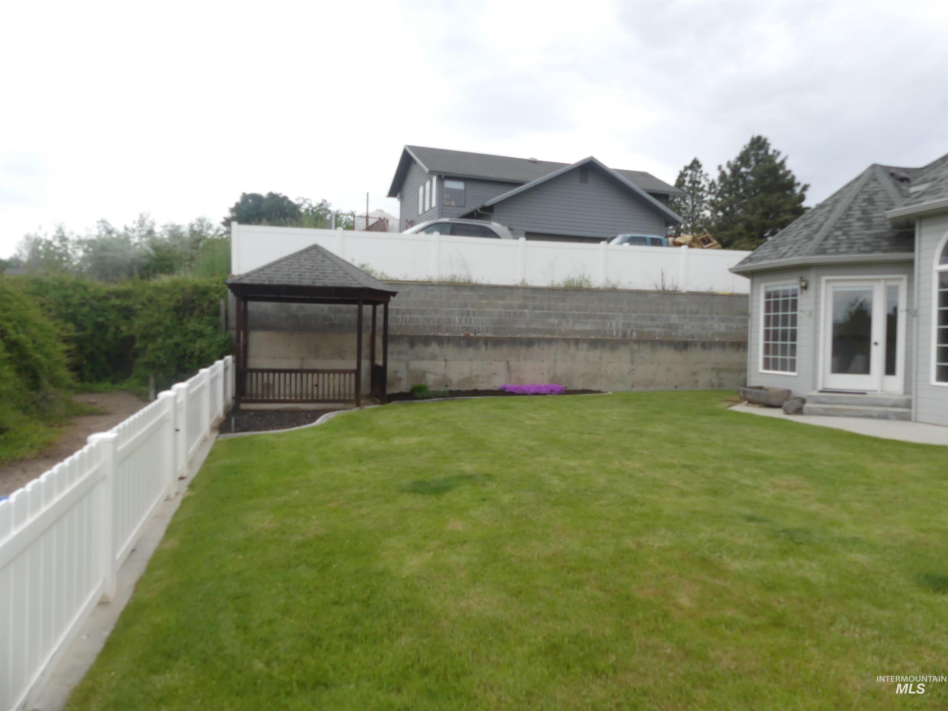 Fenced backyard with a gazebo