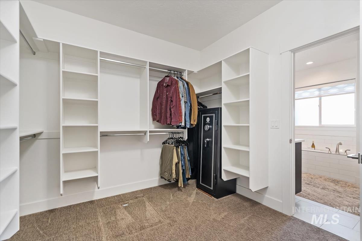 Spacious closet featuring carpet and tile patterned flooring