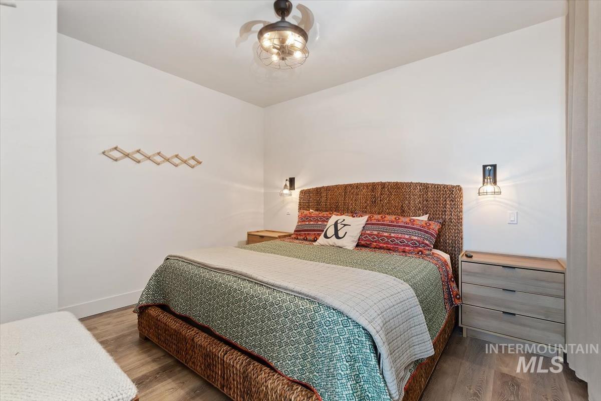 Bedroom featuring wood finished floors and baseboards