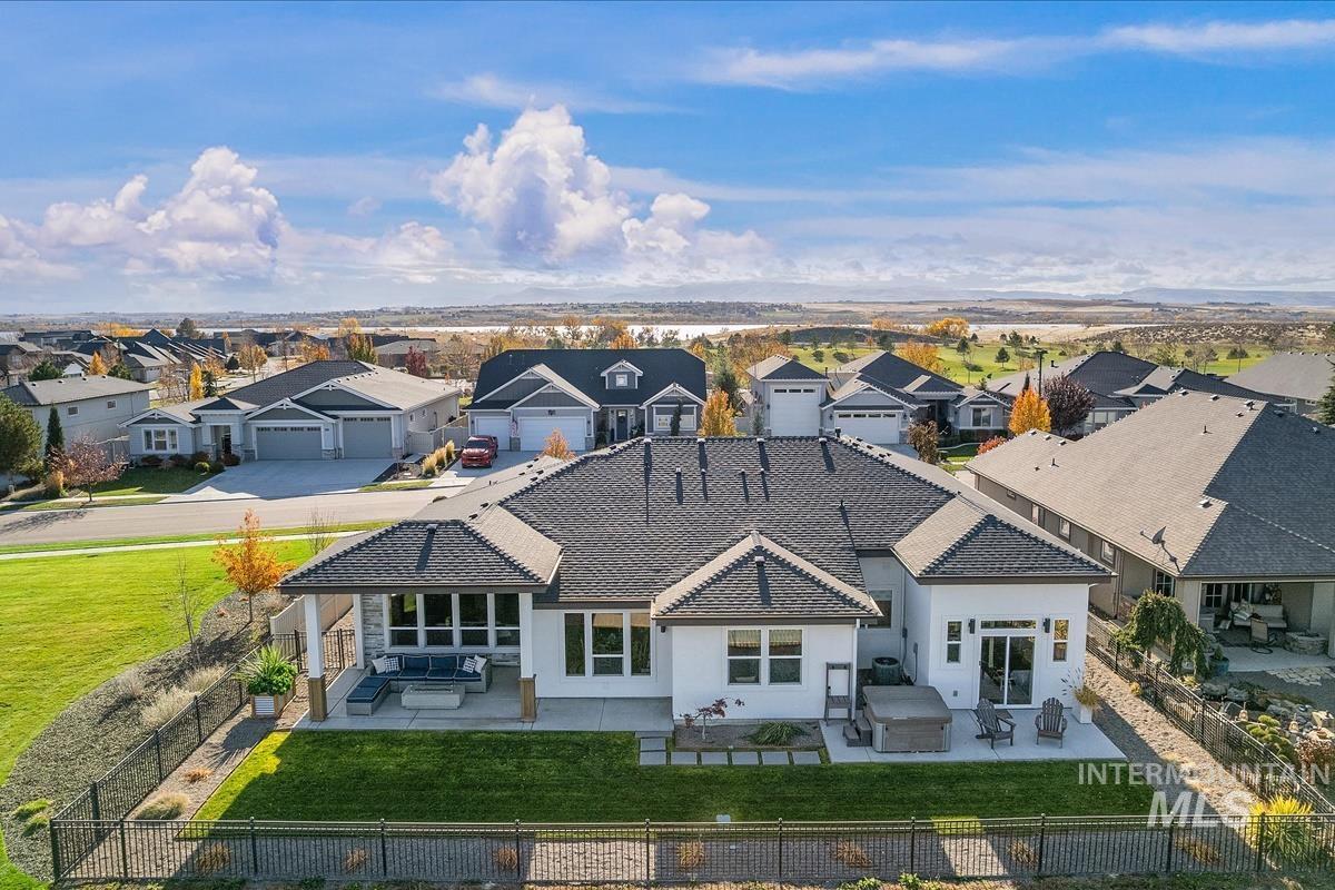 Back of house featuring a patio area, outdoor lounge area, a fenced backyard, and stucco siding