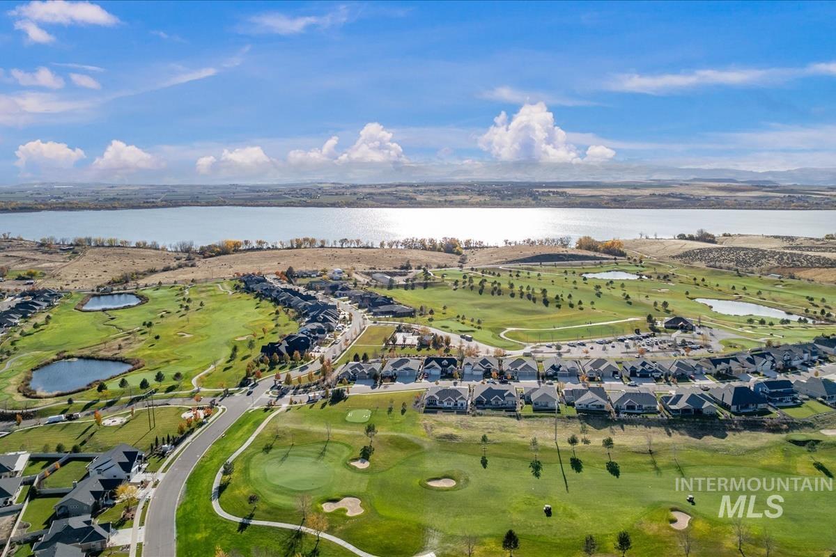 Aerial overview of property's location with a nearby body of water and nearby suburban area