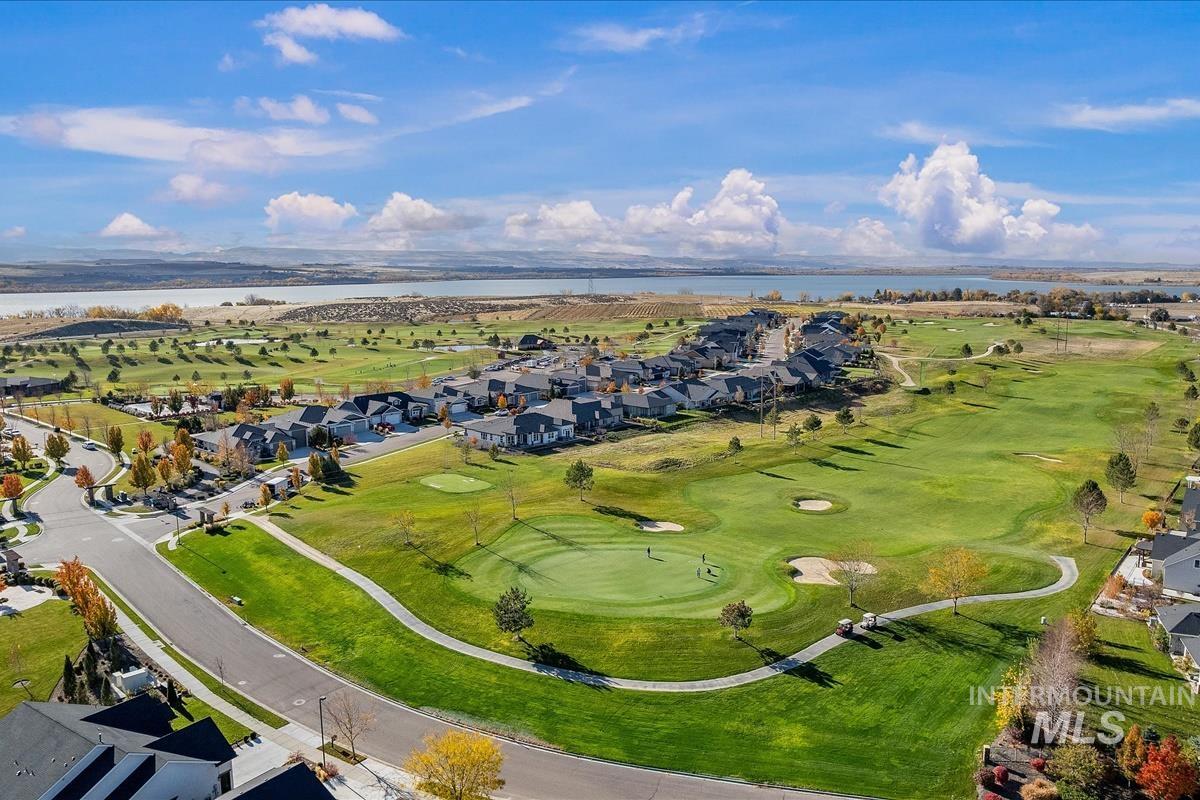 Aerial view of property's location featuring a large body of water and nearby suburban area