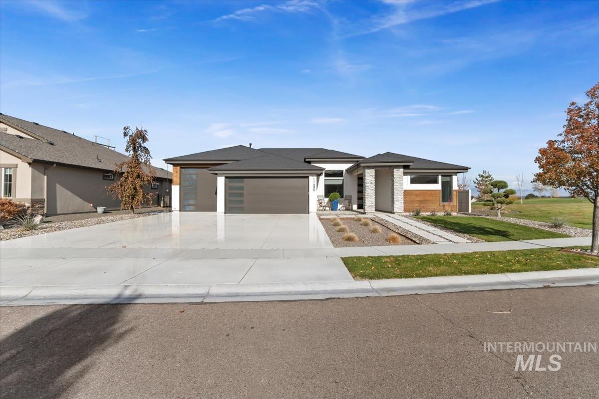 Prairie-style house featuring concrete driveway and a garage