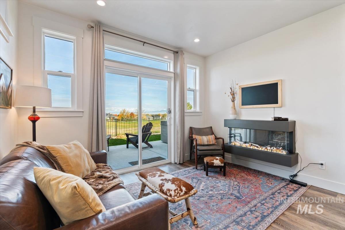 Living area with wood finished floors and recessed lighting