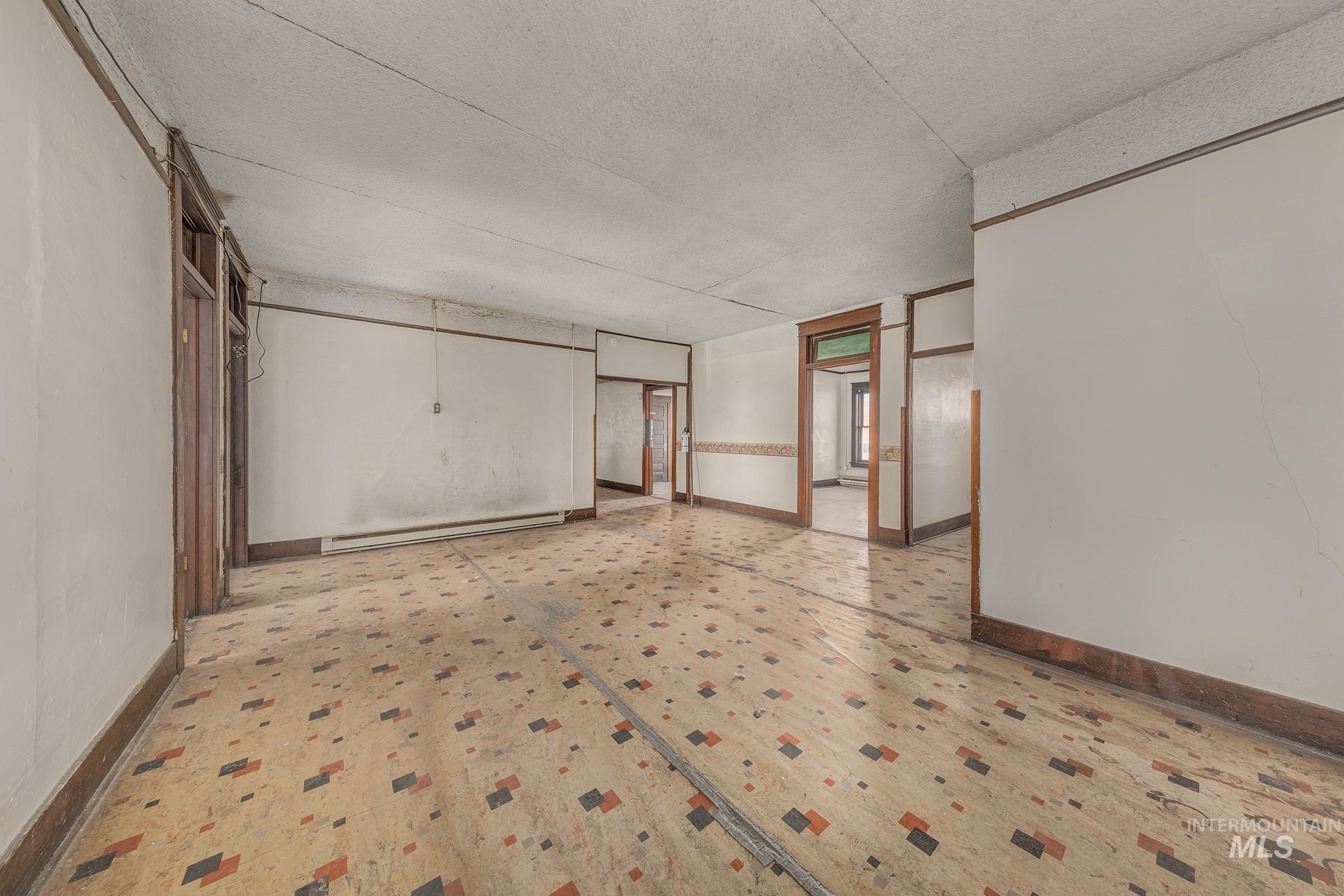 Spare room with a textured ceiling and a baseboard radiator