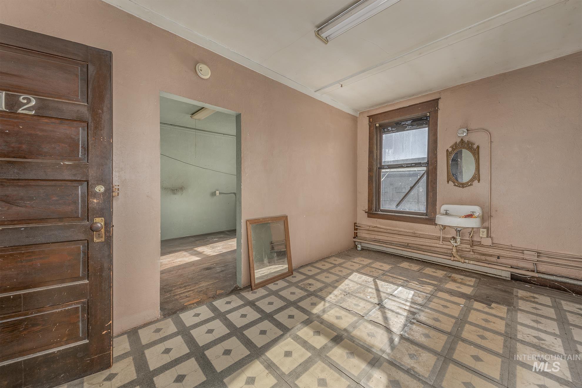 Empty room featuring tile patterned floors