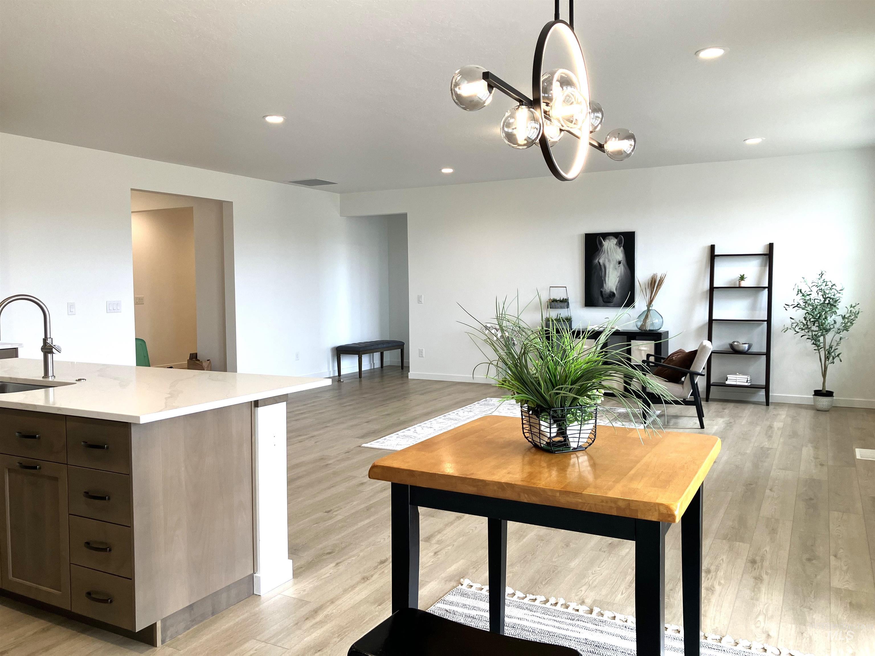 Living room with light wood-style floors and recessed lighting