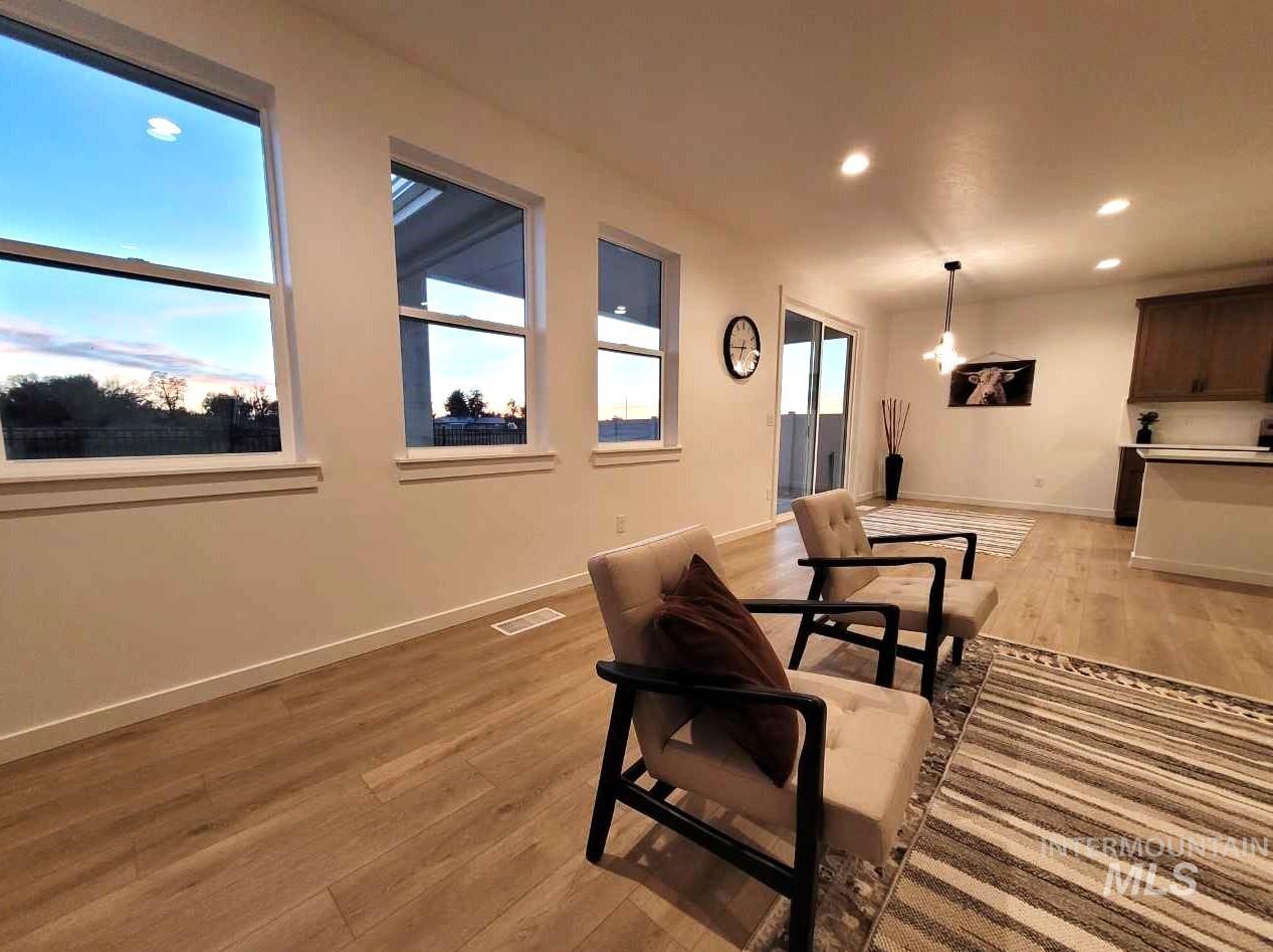 Dining room with light wood-style floors and recessed lighting