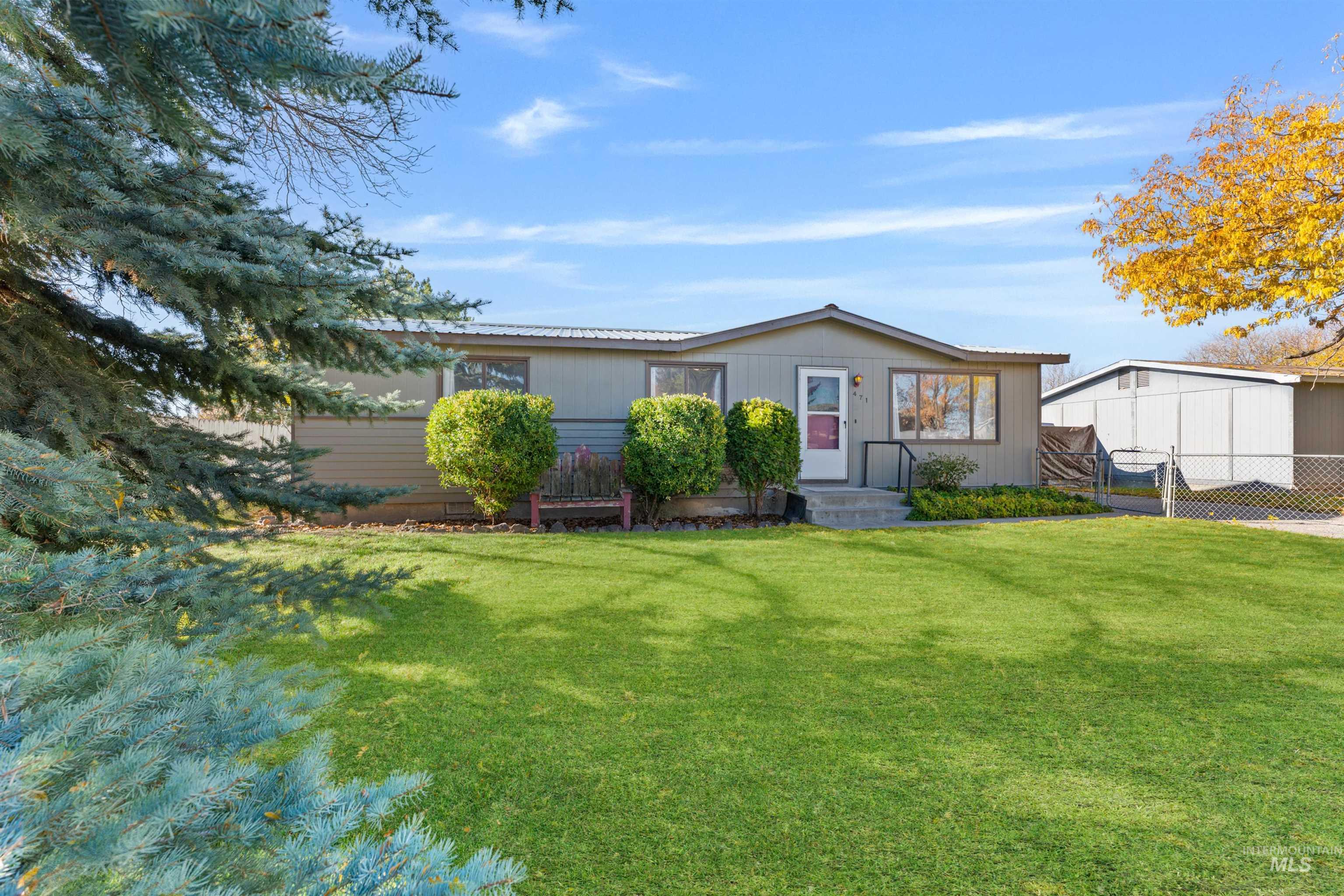 View of front facade with a gate and a metal roof
