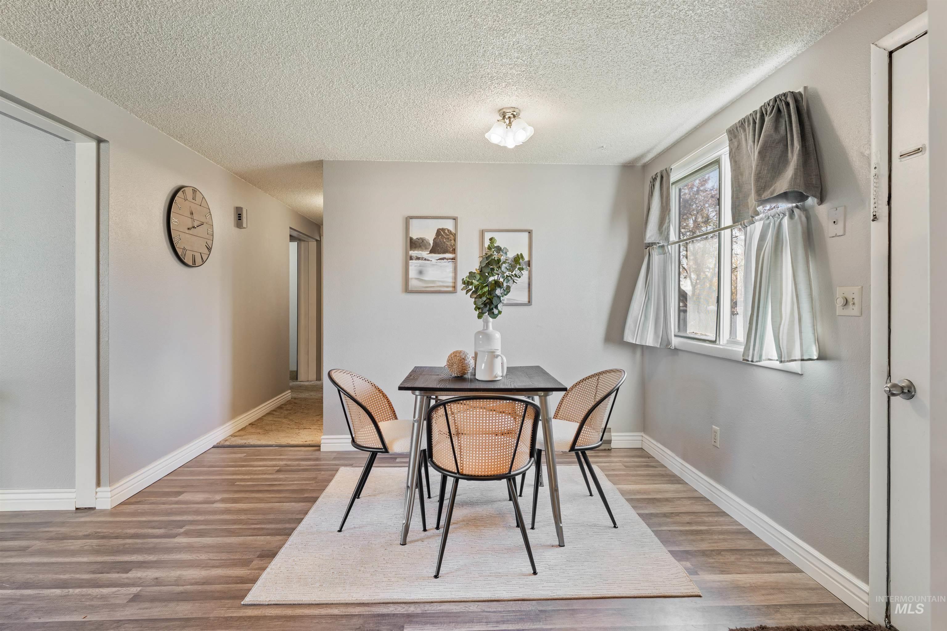 Dining room featuring a textured ceiling and light wood-style flooring