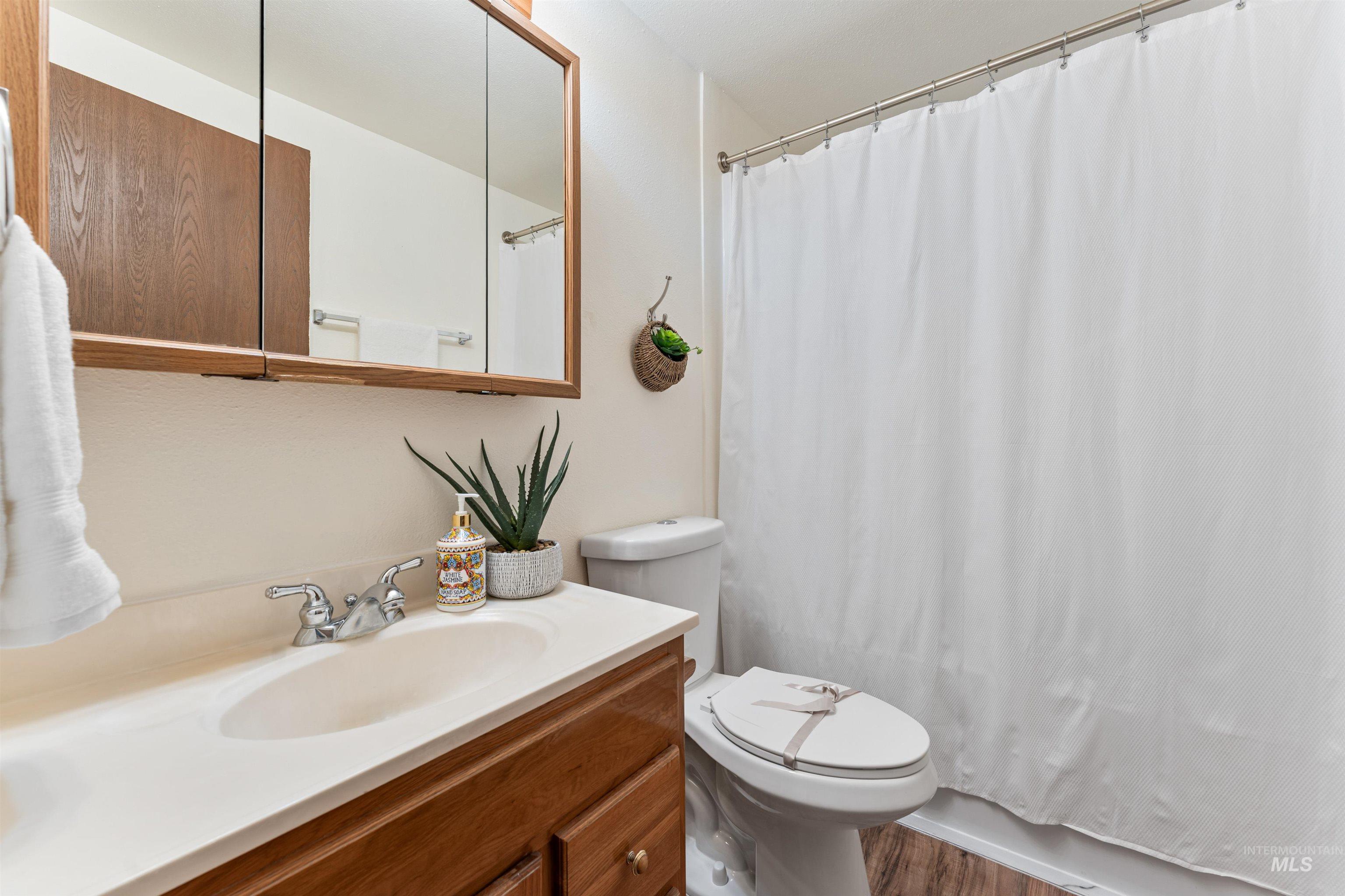 Bathroom with vanity and wood finished floors