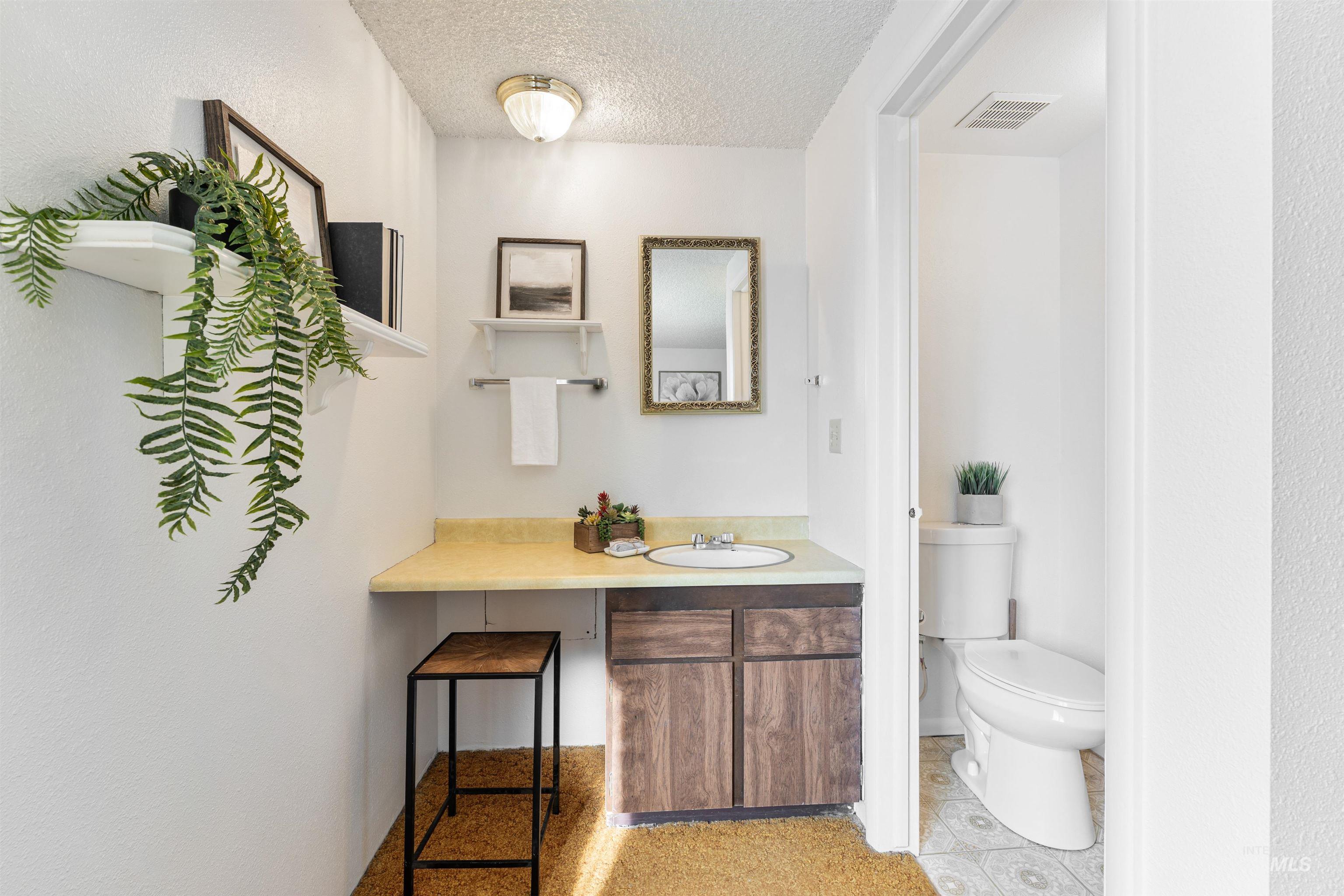 Bathroom featuring vanity and a textured ceiling