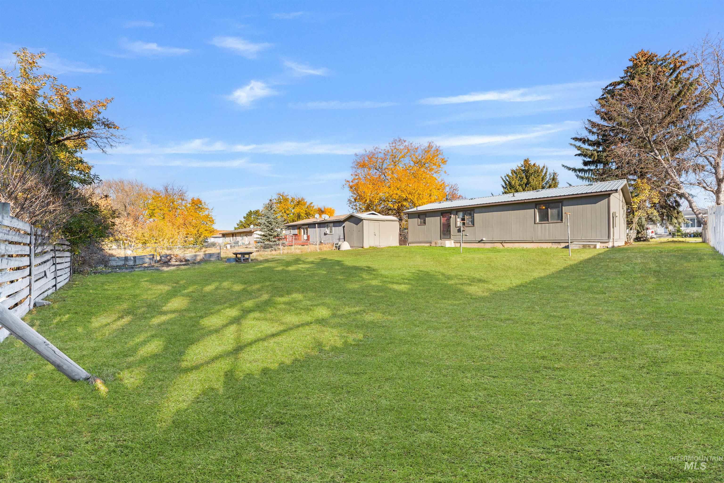 Fenced backyard with a storage shed