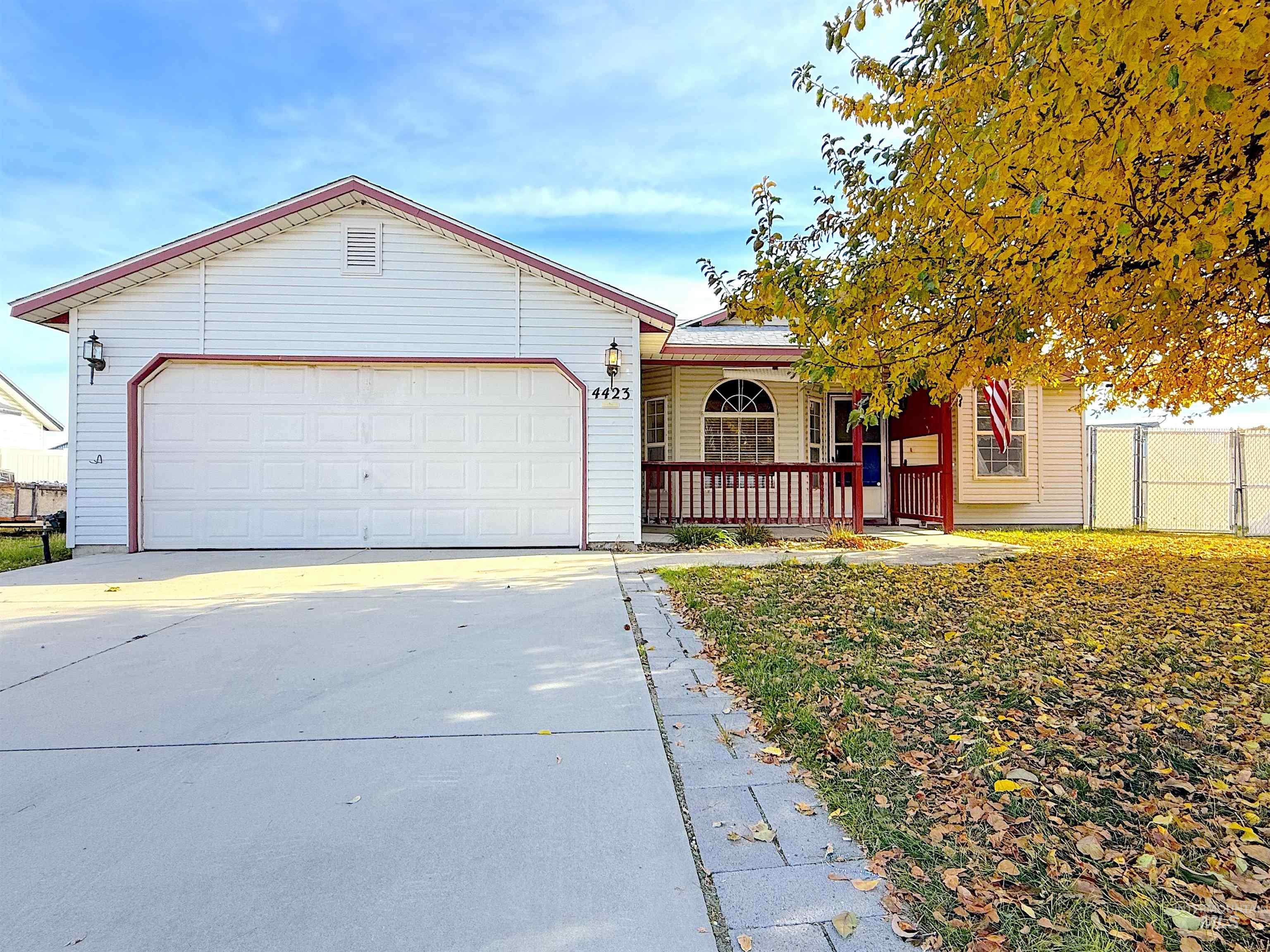 Single story home with driveway, a garage, and covered porch