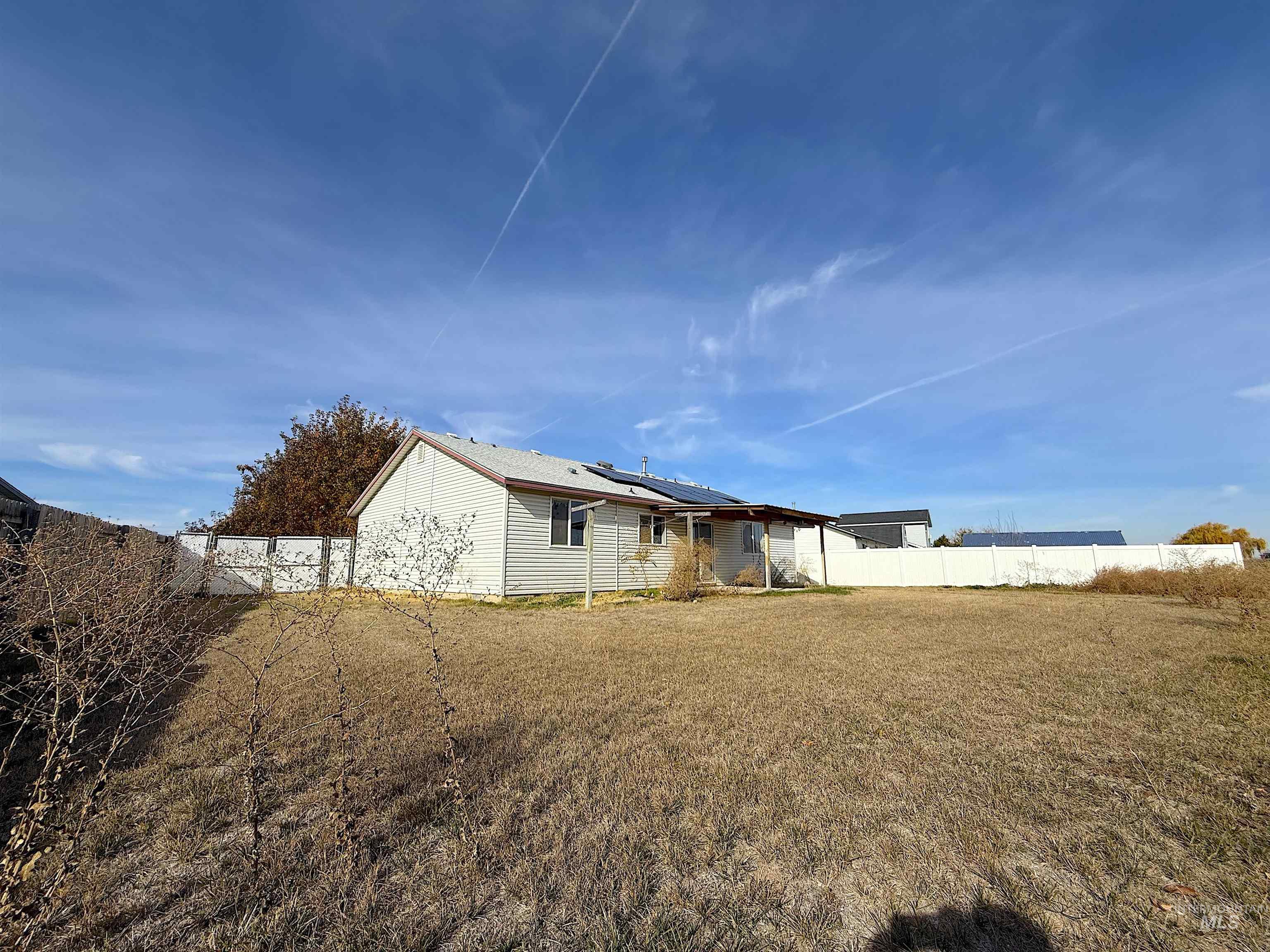View of home's exterior with roof mounted solar panels