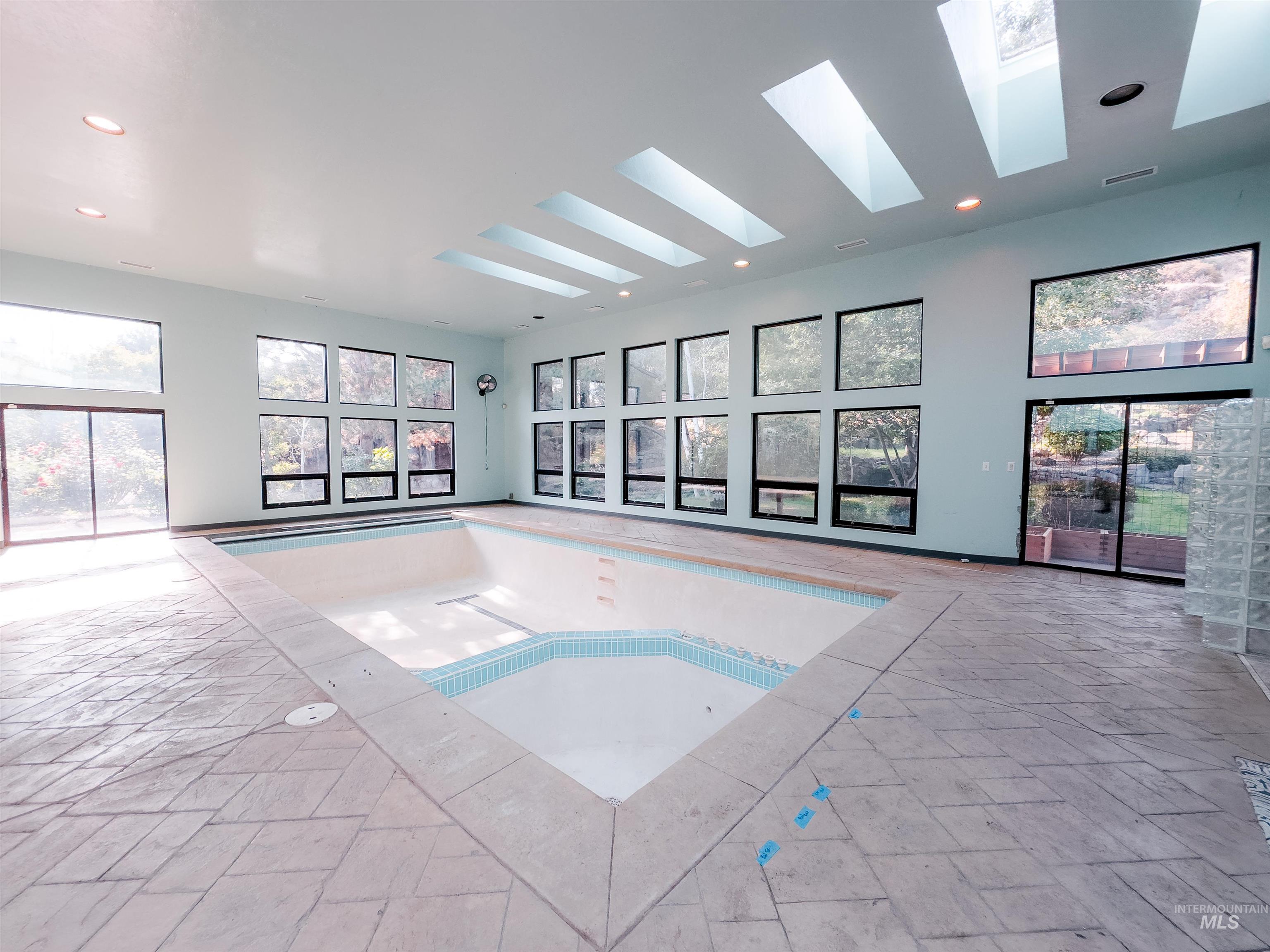 Indoor pool featuring a skylight