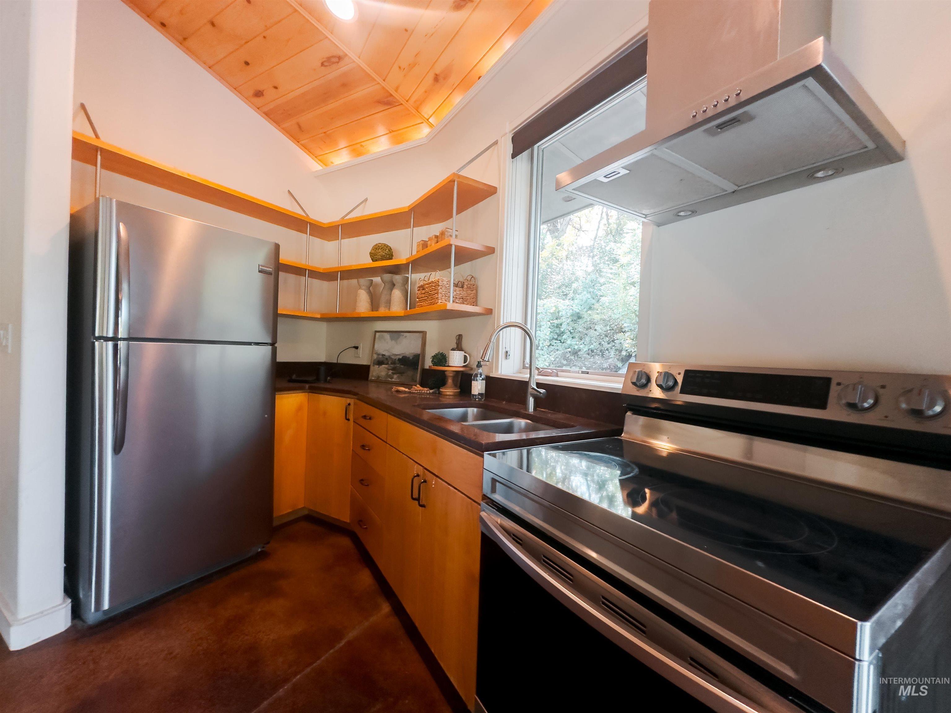 Kitchen featuring appliances with stainless steel finishes, open shelves, exhaust hood, wooden ceiling, and light brown cabinets
