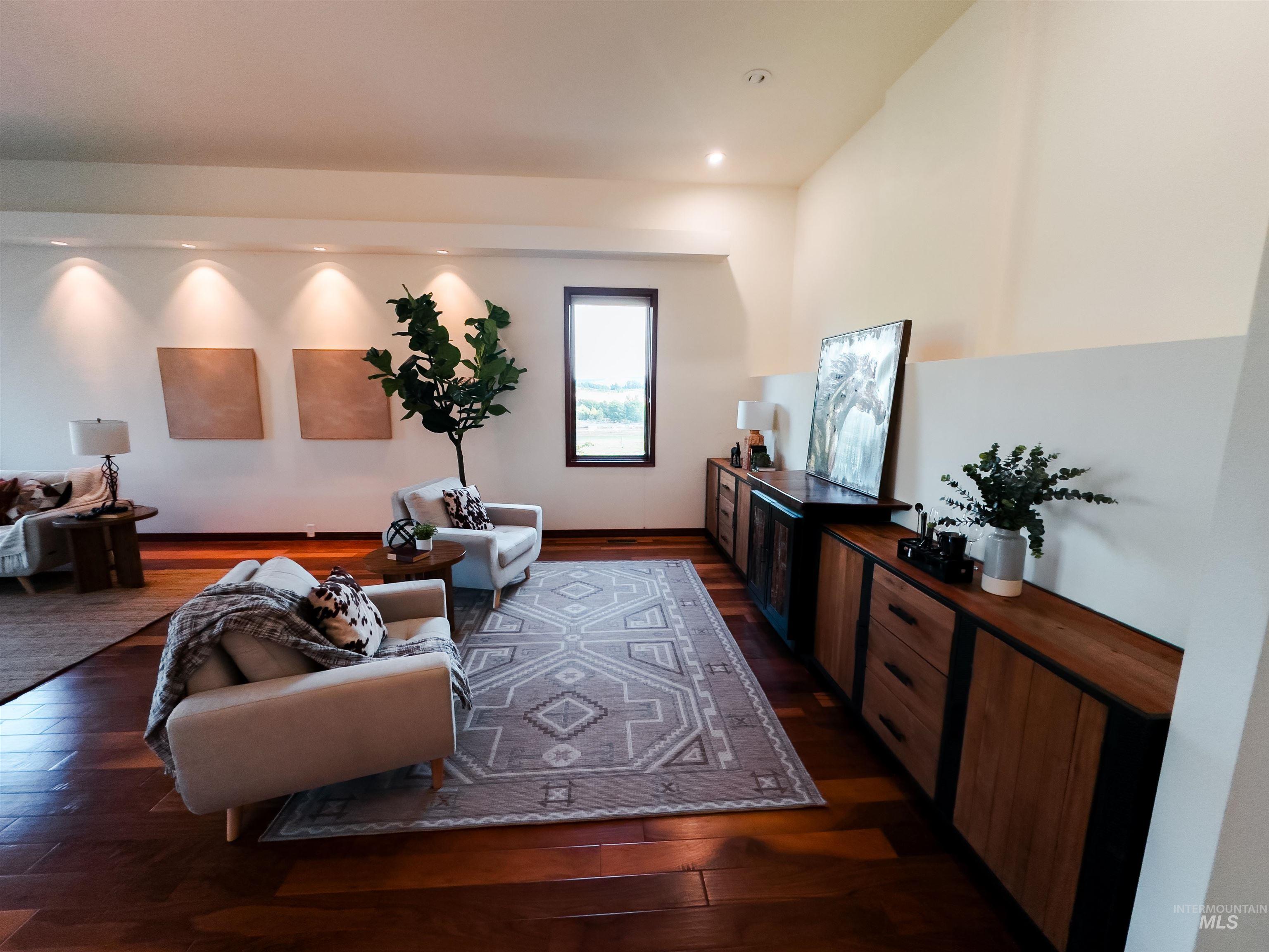 Living area with dark wood-style floors and recessed lighting