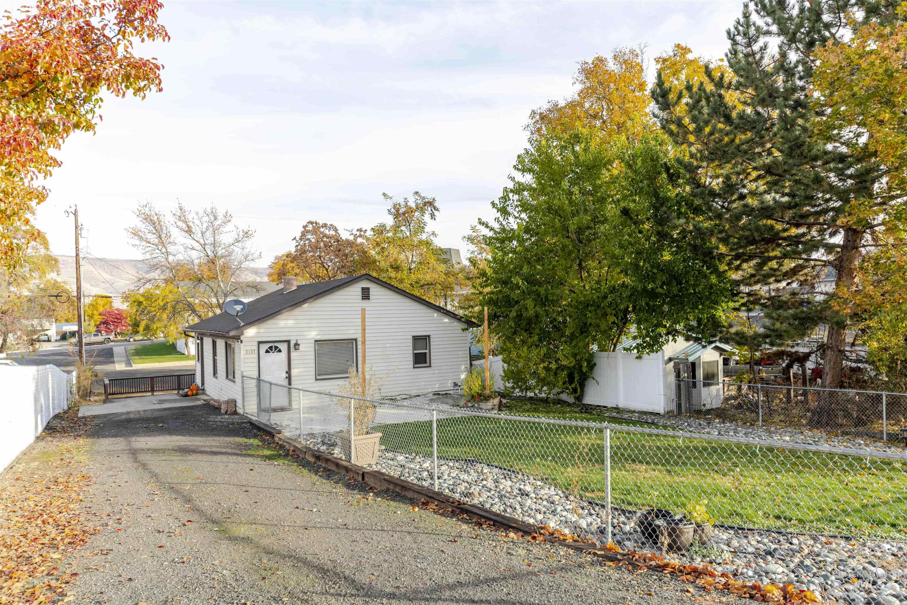 View of side of property with a fenced front yard and a chimney