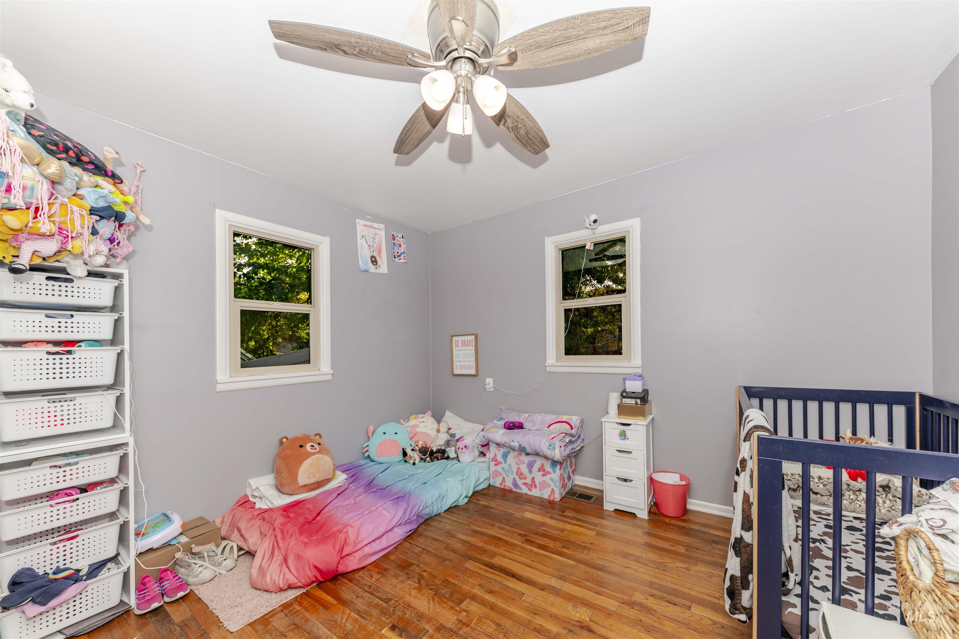 Bedroom featuring light wood-style floors and a ceiling fan