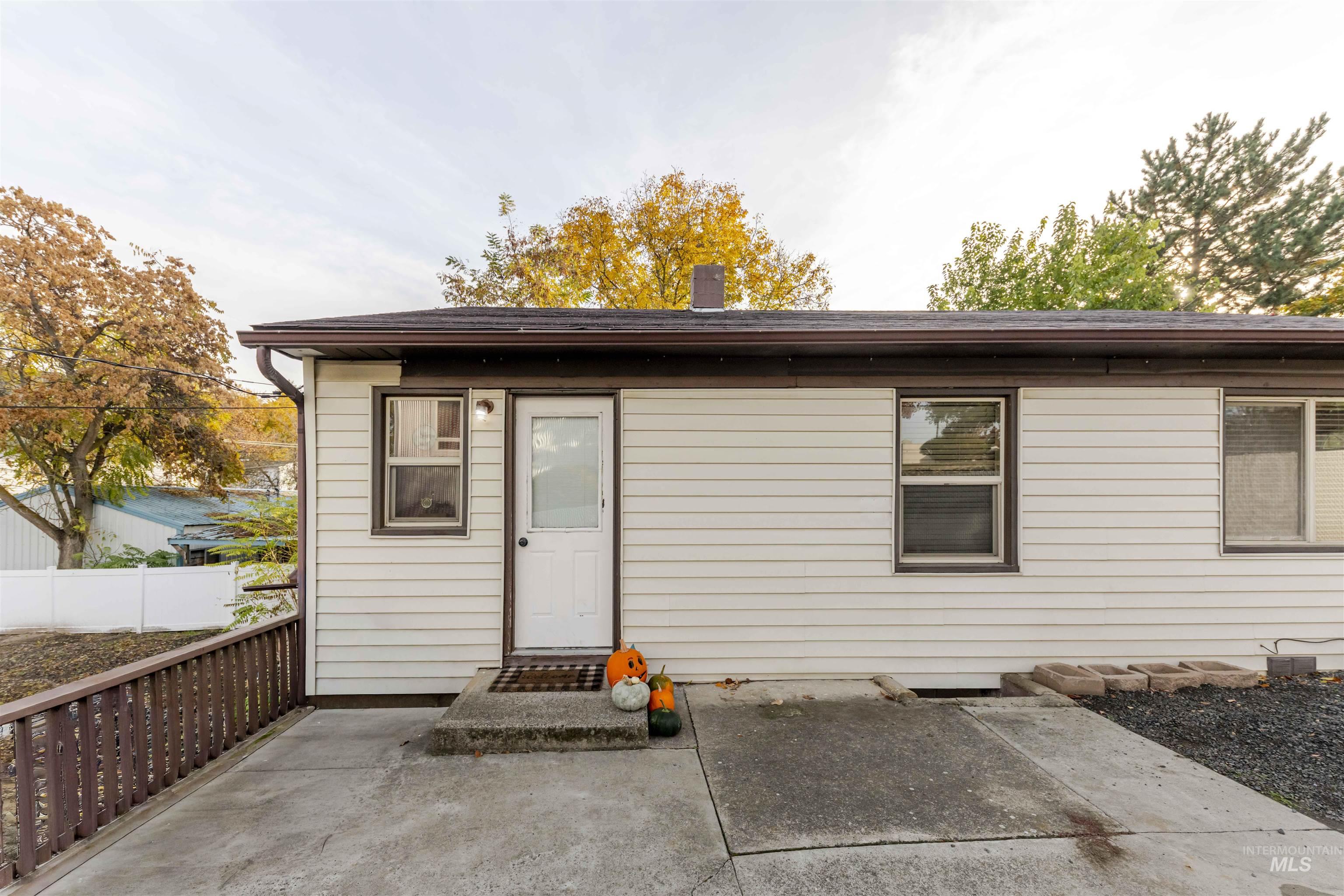 Rear view of property with a chimney and a patio area