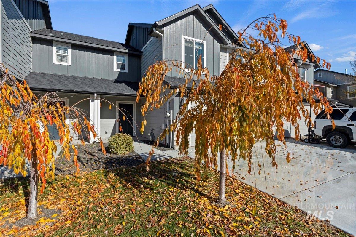 View of front of home featuring a shingled roof, board and batten siding, and a porch