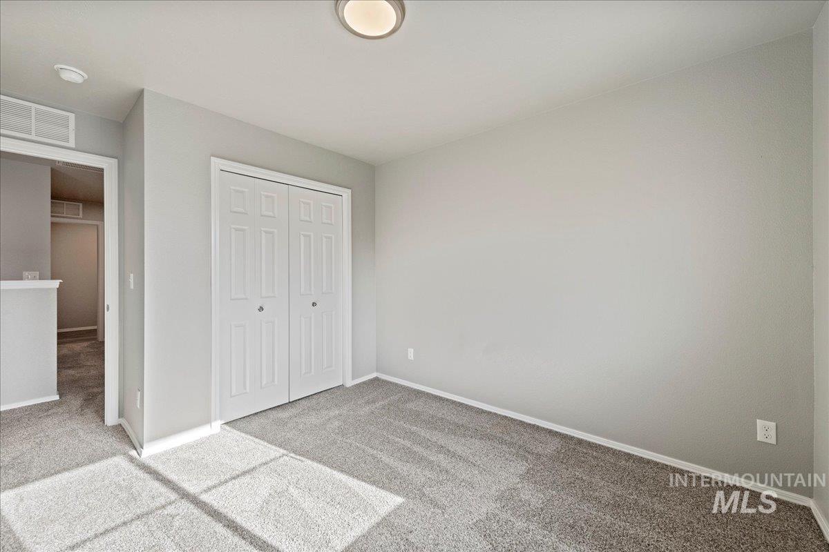 Unfurnished bedroom with carpet floors and a closet