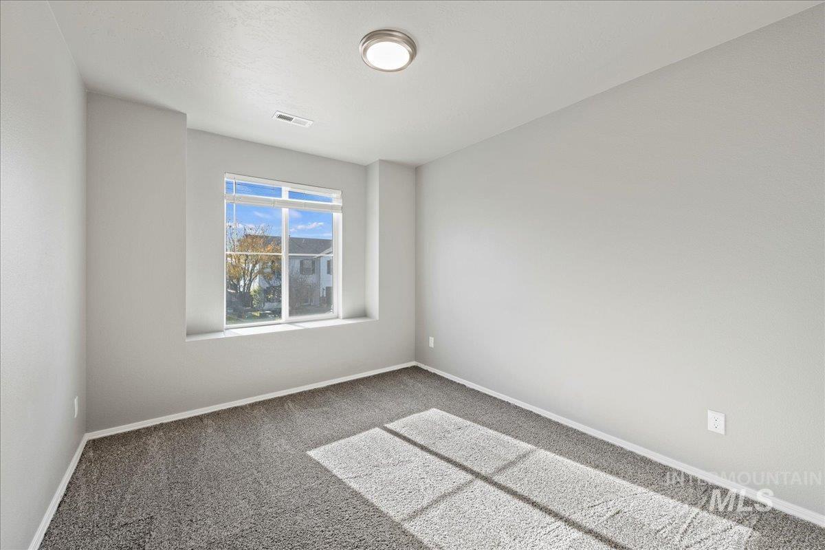 Unfurnished room featuring carpet flooring and baseboards